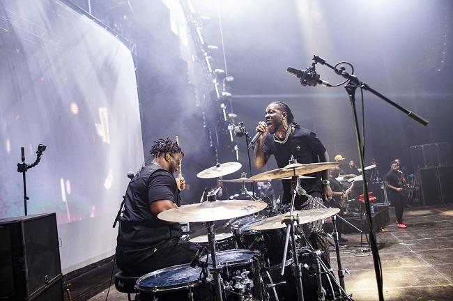 Burna Boy on a show with his Band Drummer