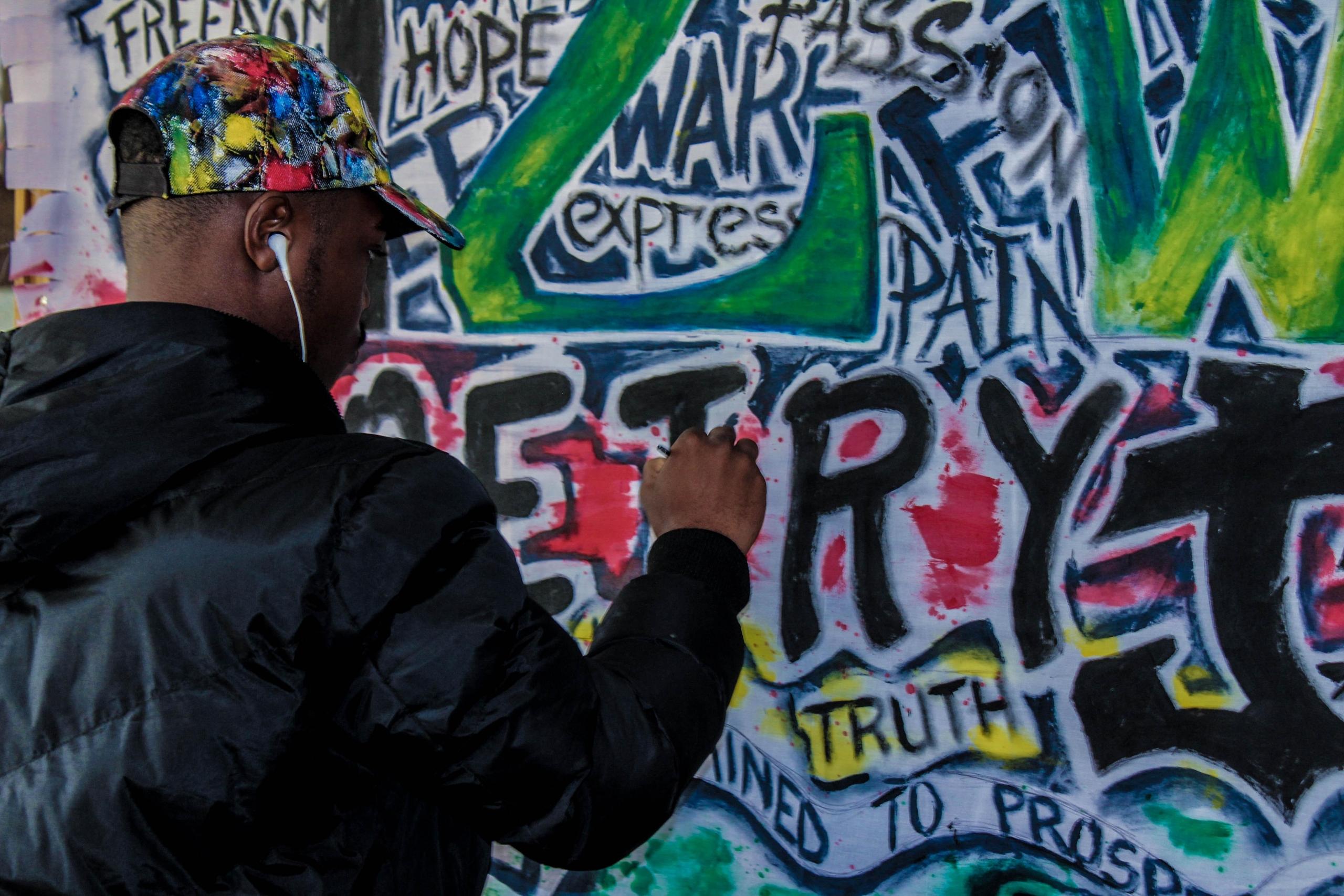 An artist doodling on the wall.