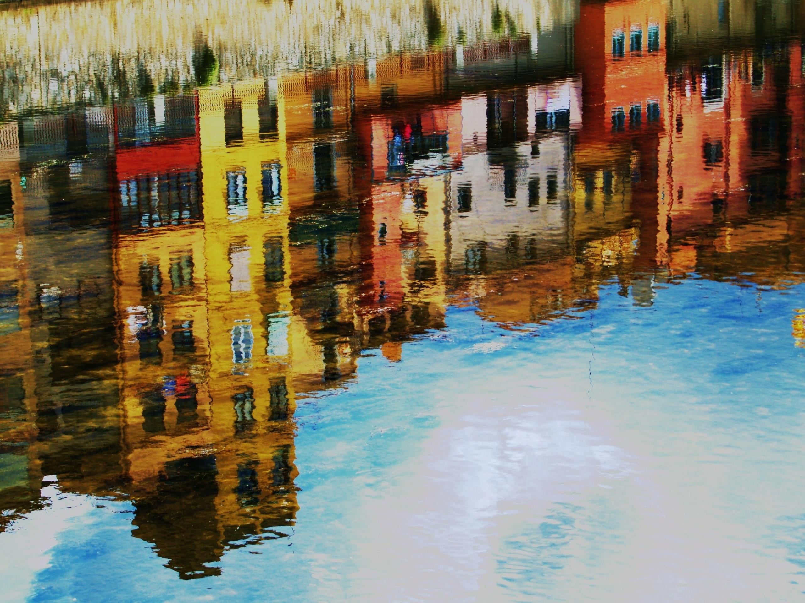 A painting that shows a view of a building from the water