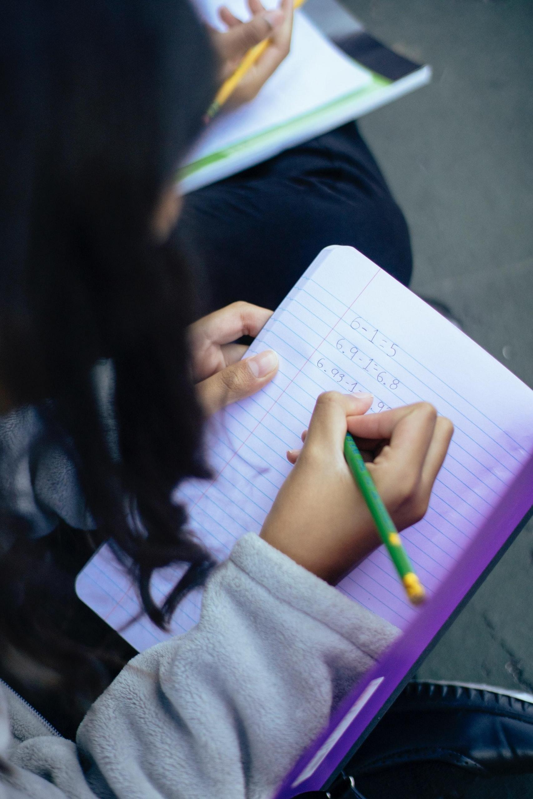 Small girl writing on a note