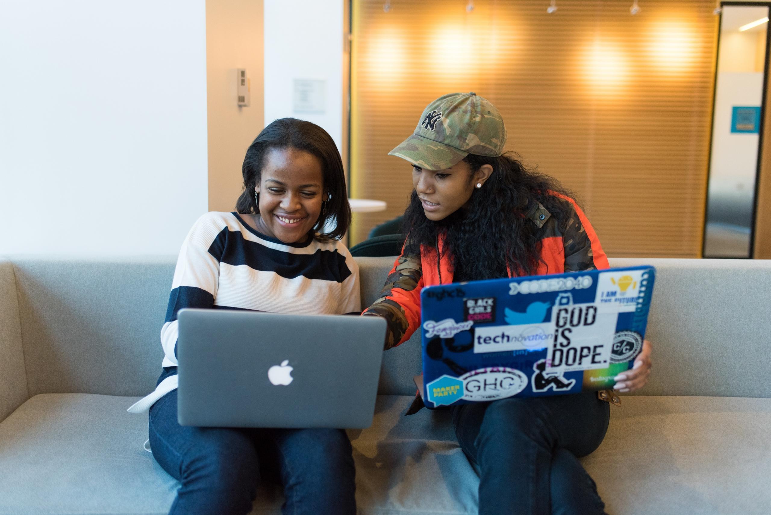 Two black ladies with laptops