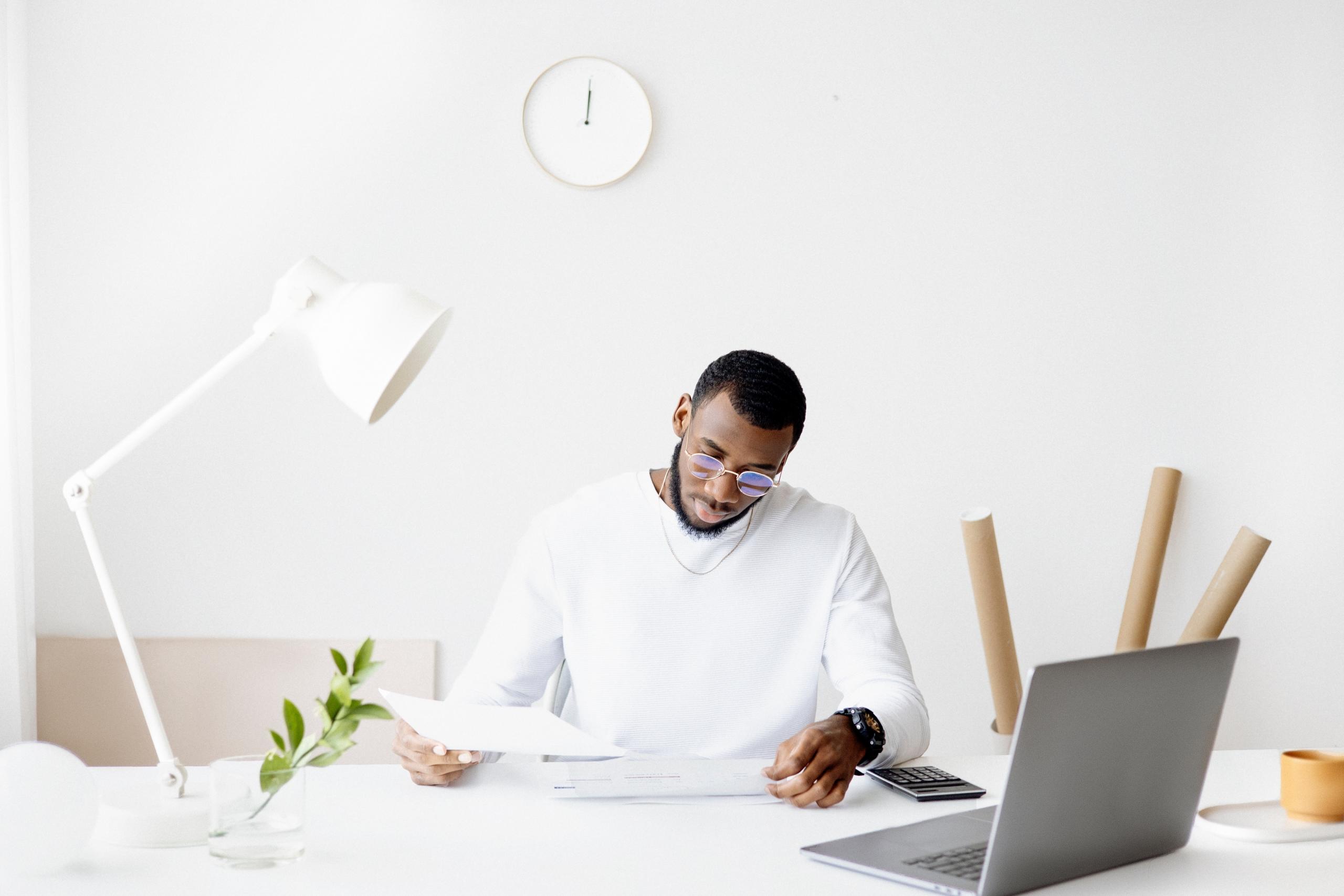 A man with a book and laptop