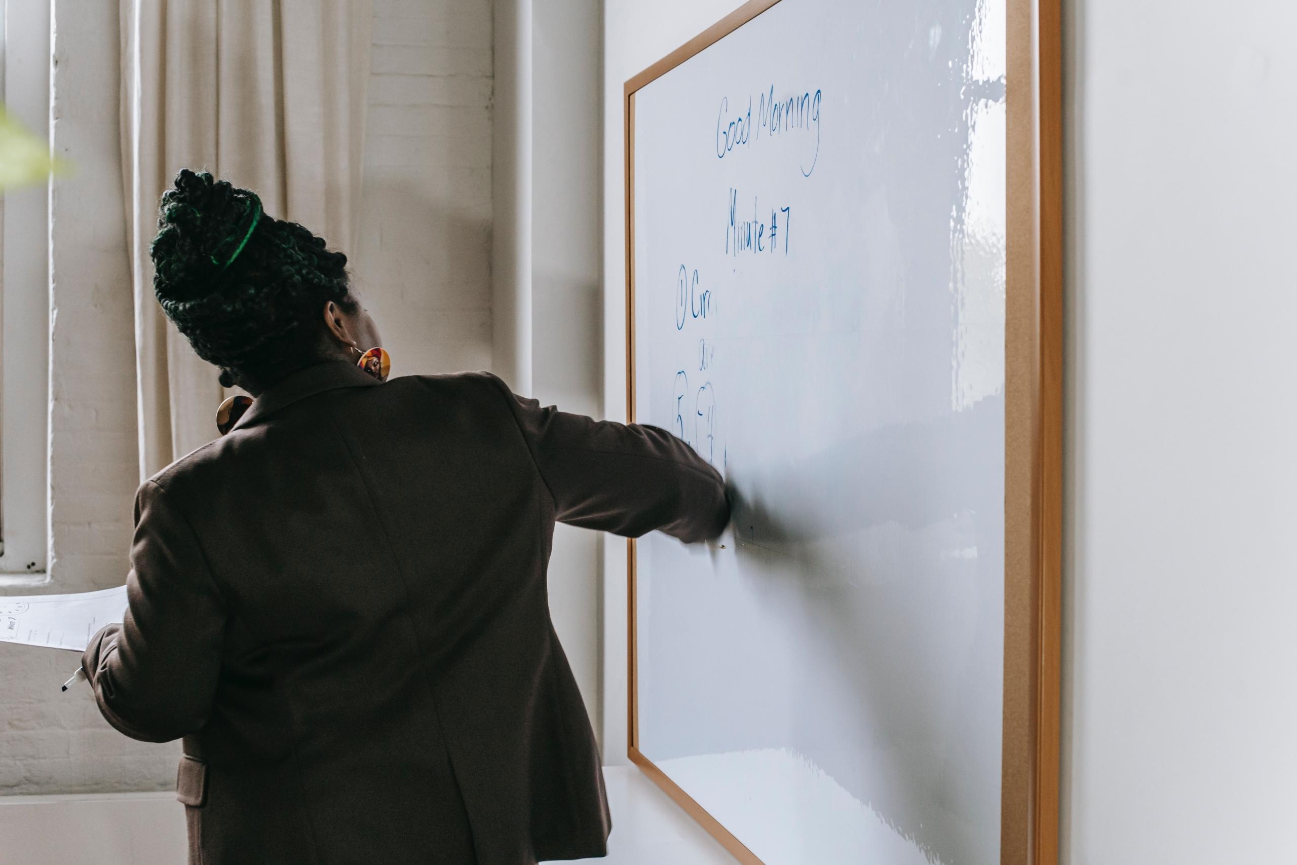 A tutor writing on a white board