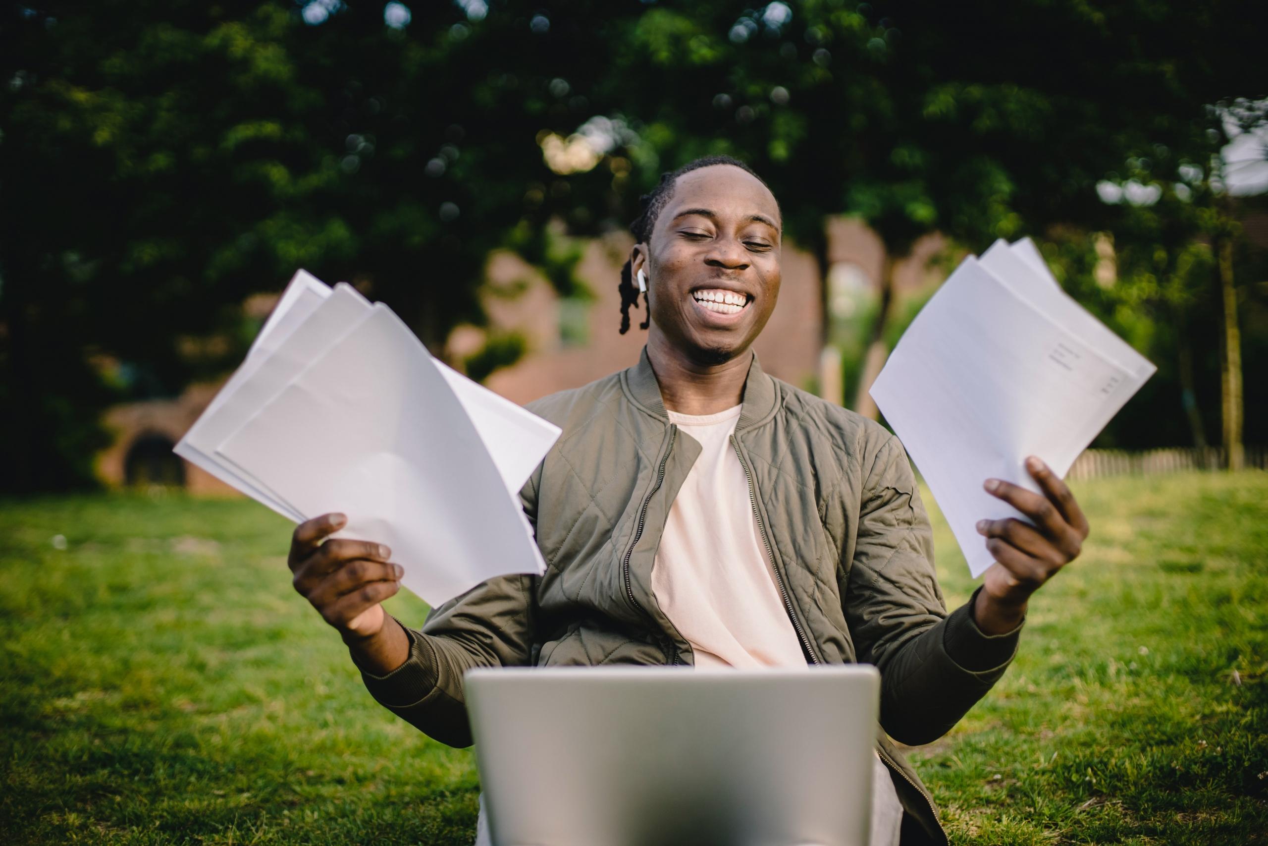 Student with papers and laptop