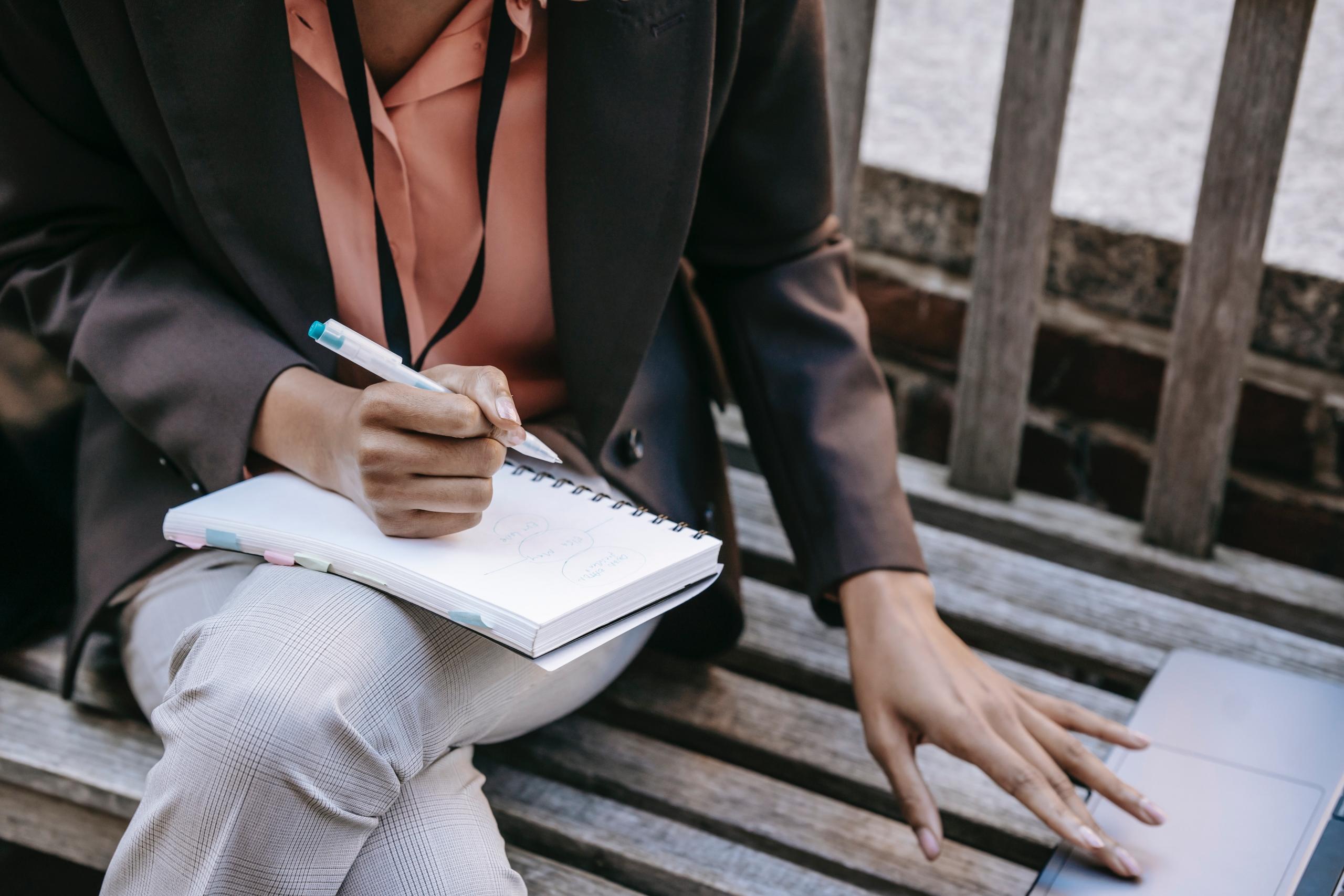 A person writing in a book