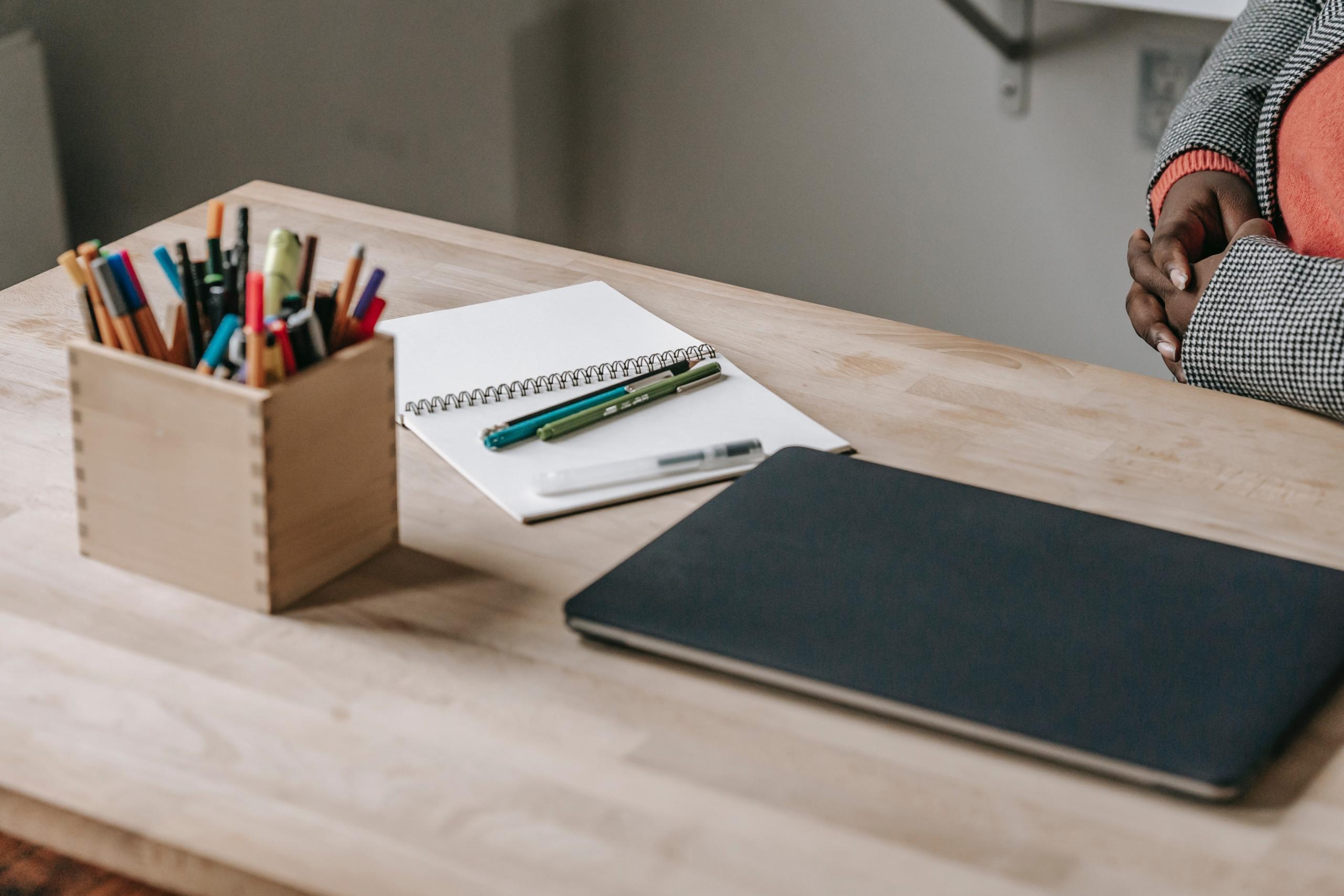 A table with book, pen, and other accessories
