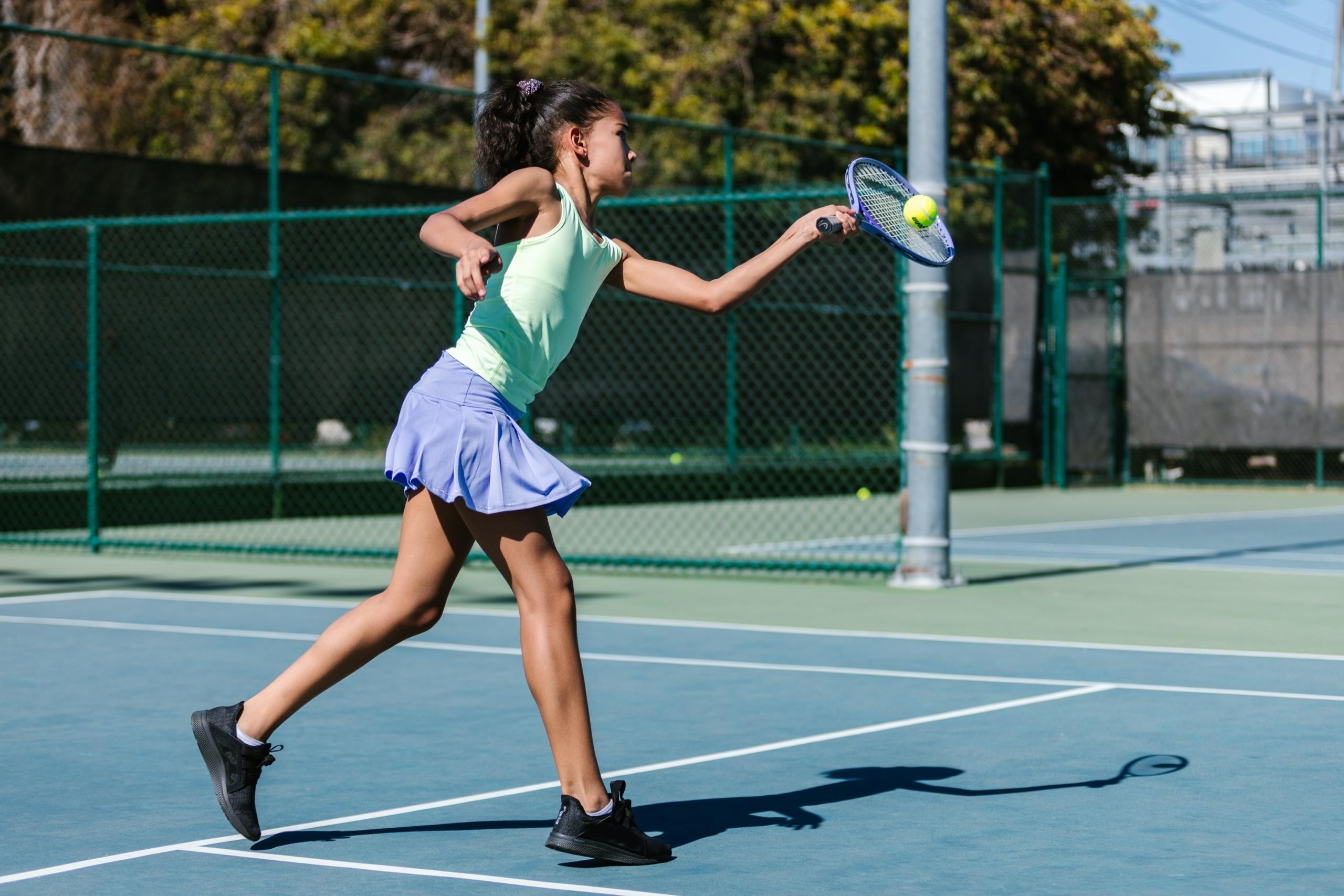 Little girl playing tennis
