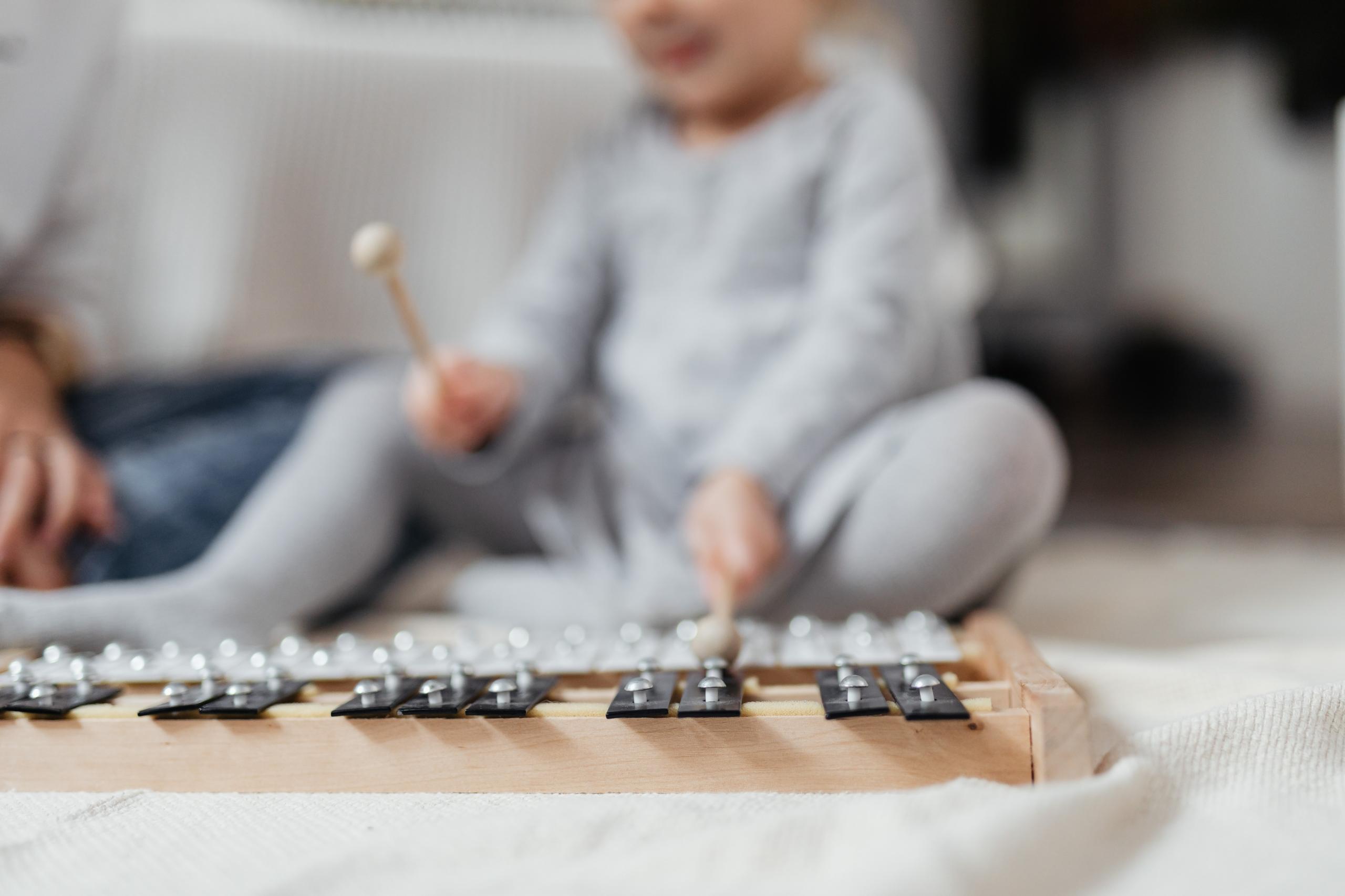 A kid playing a musical instrument