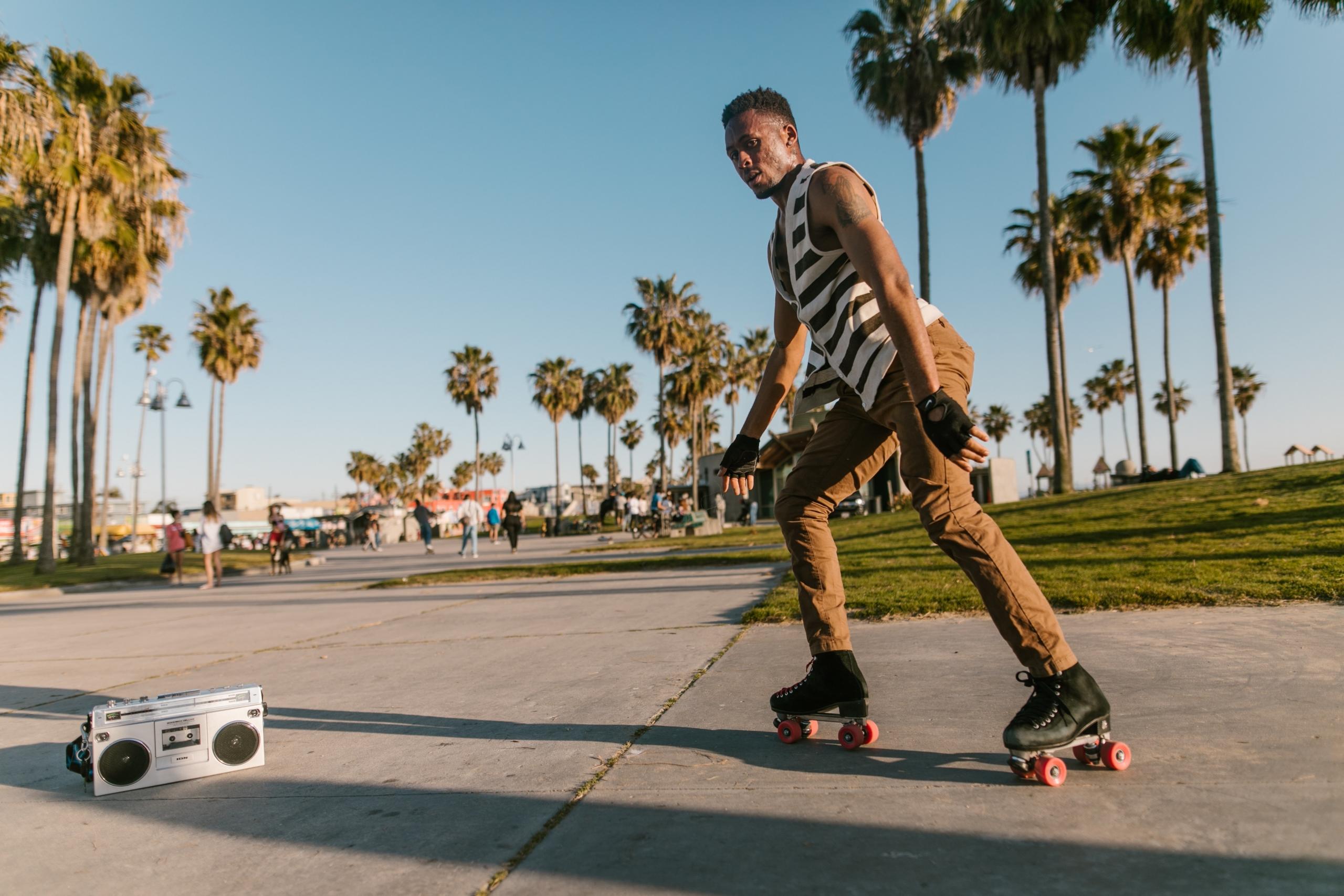 Ablack man rollerskating with a radio