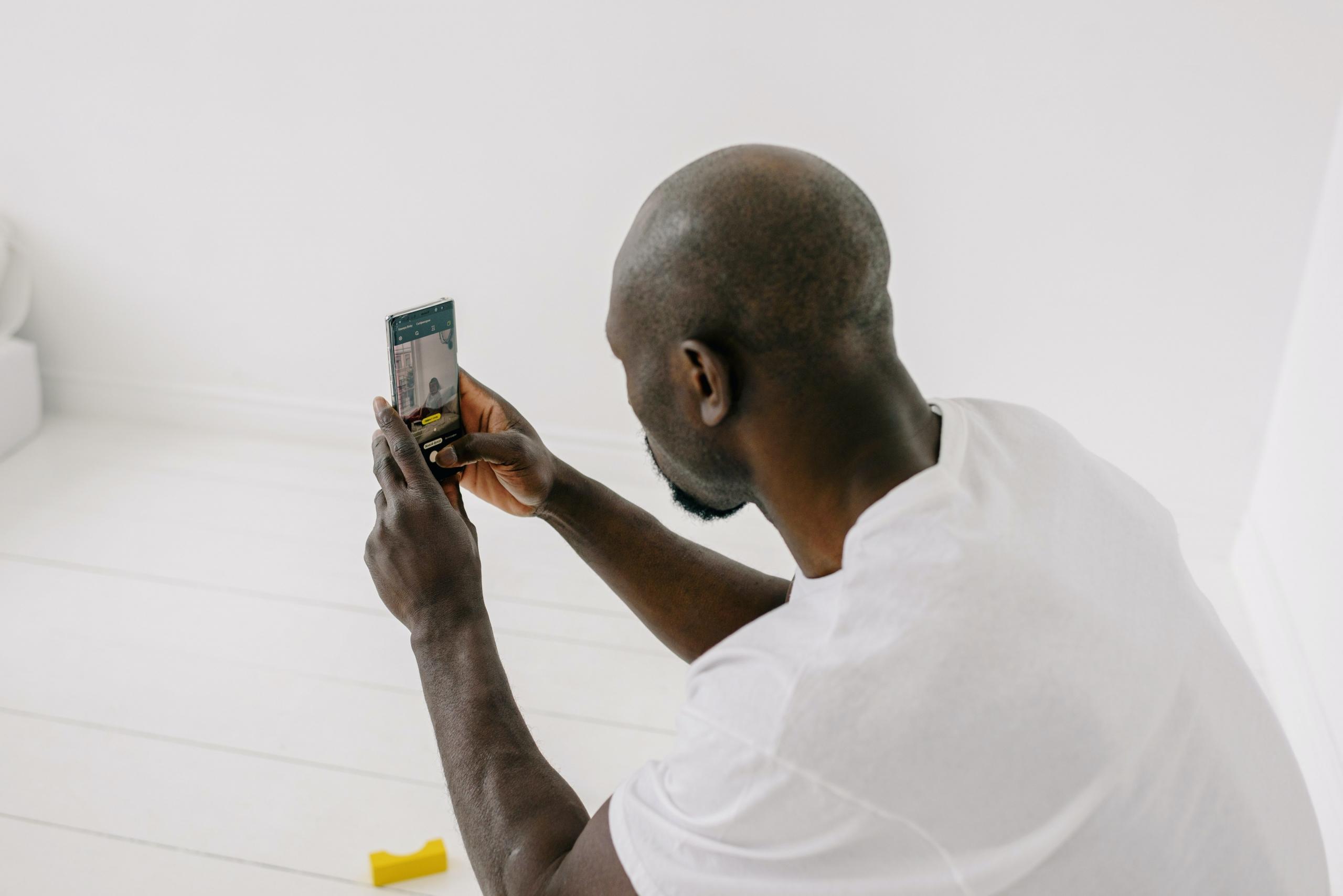 A black man with a camera