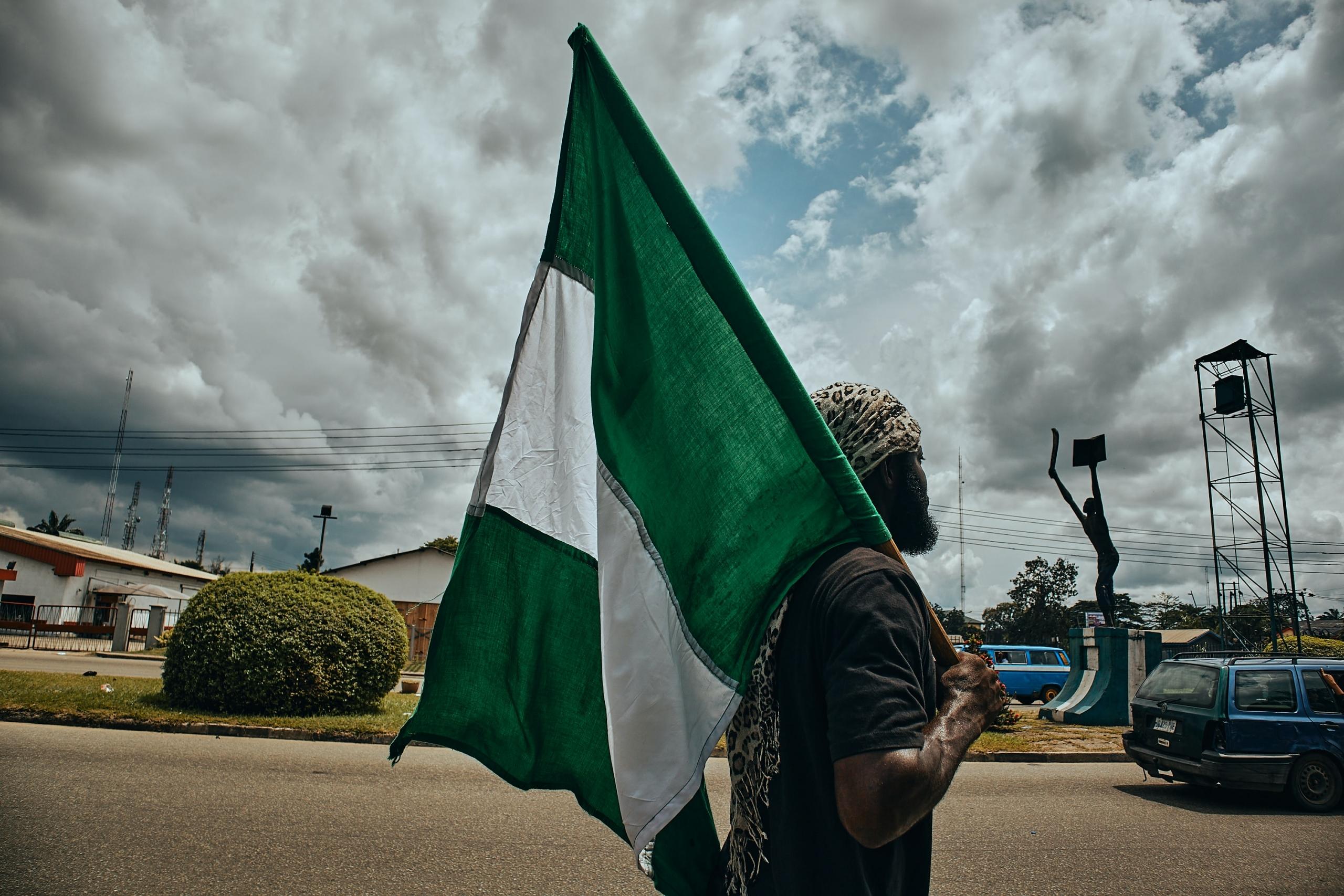 A man with a Nigerian flag