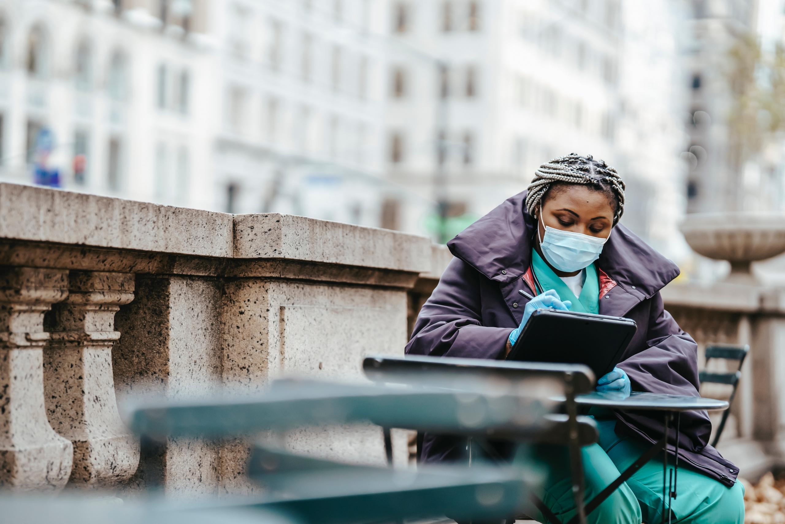 A nurse sitting alone and writing