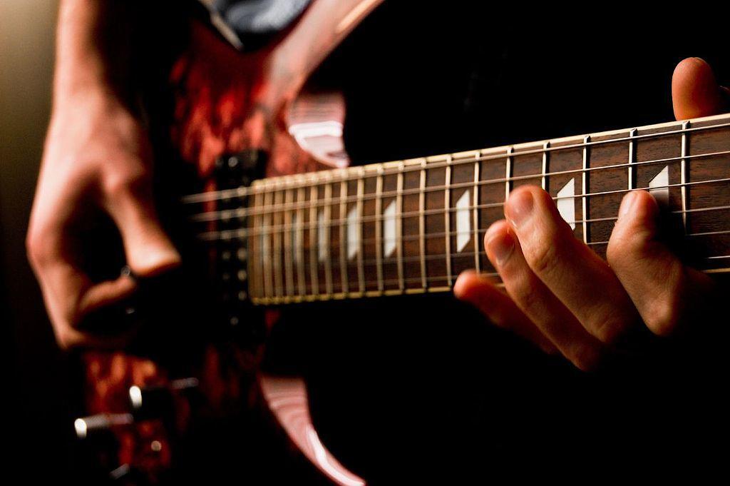A guitarist plays a rock guitar.