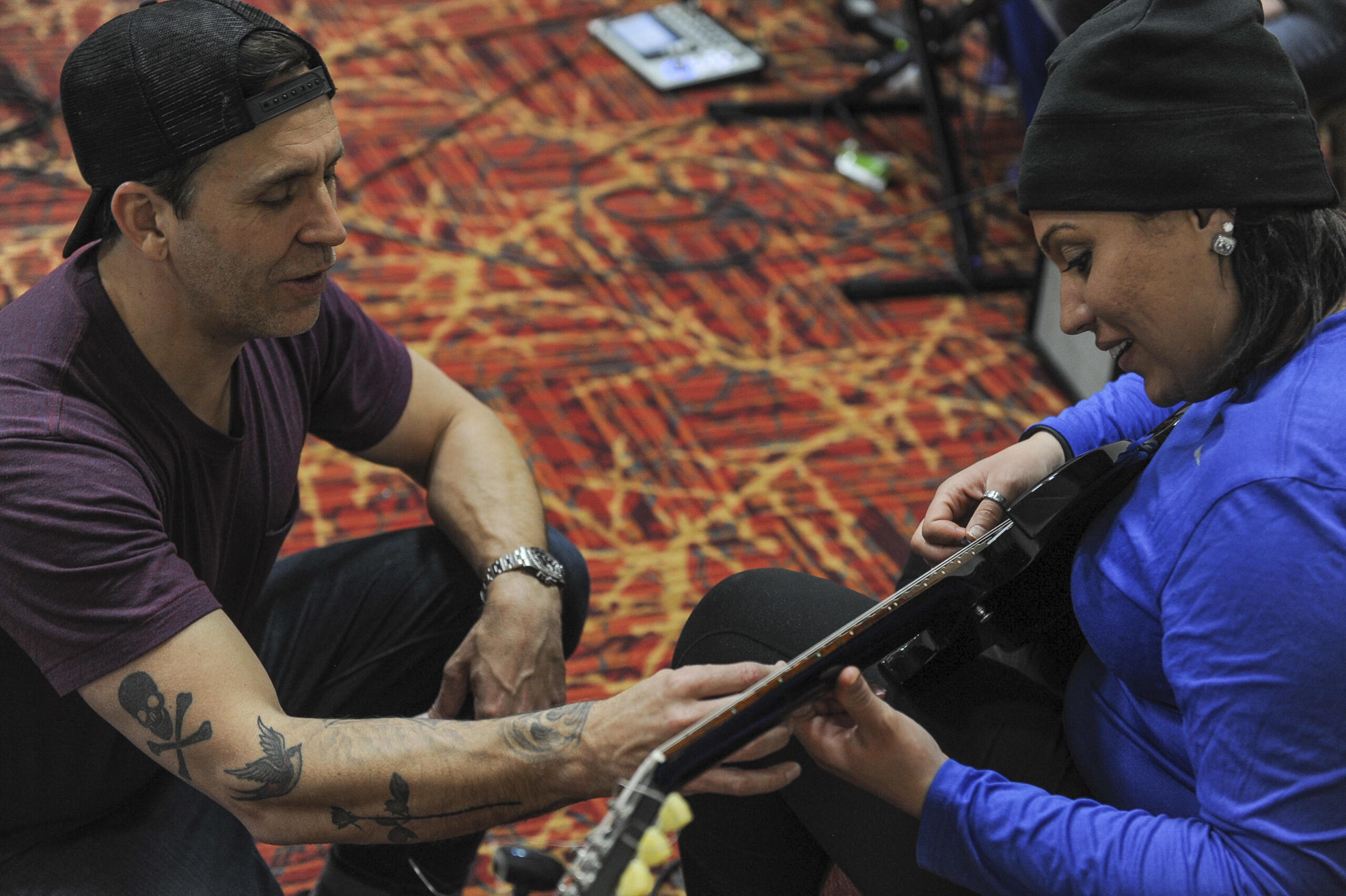 a guitar teacher with a student