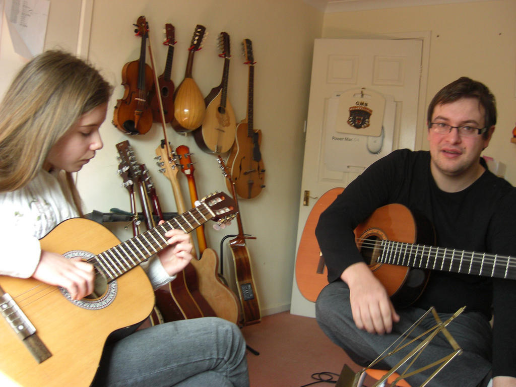 A guitar teacher and student