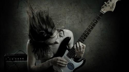 Someone playing guitar very passionately