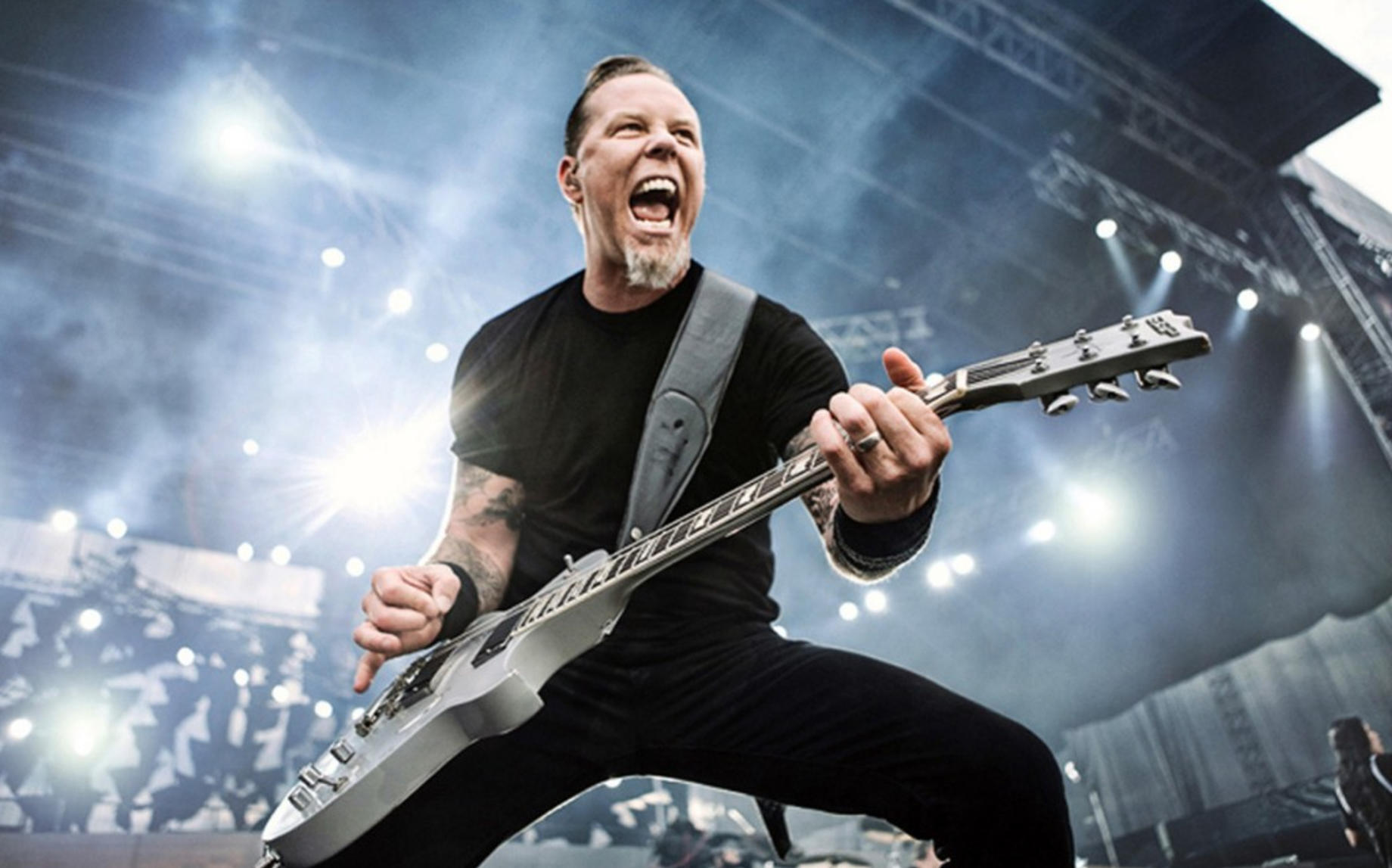 James Hetfield of Metallica playing guitar on stage