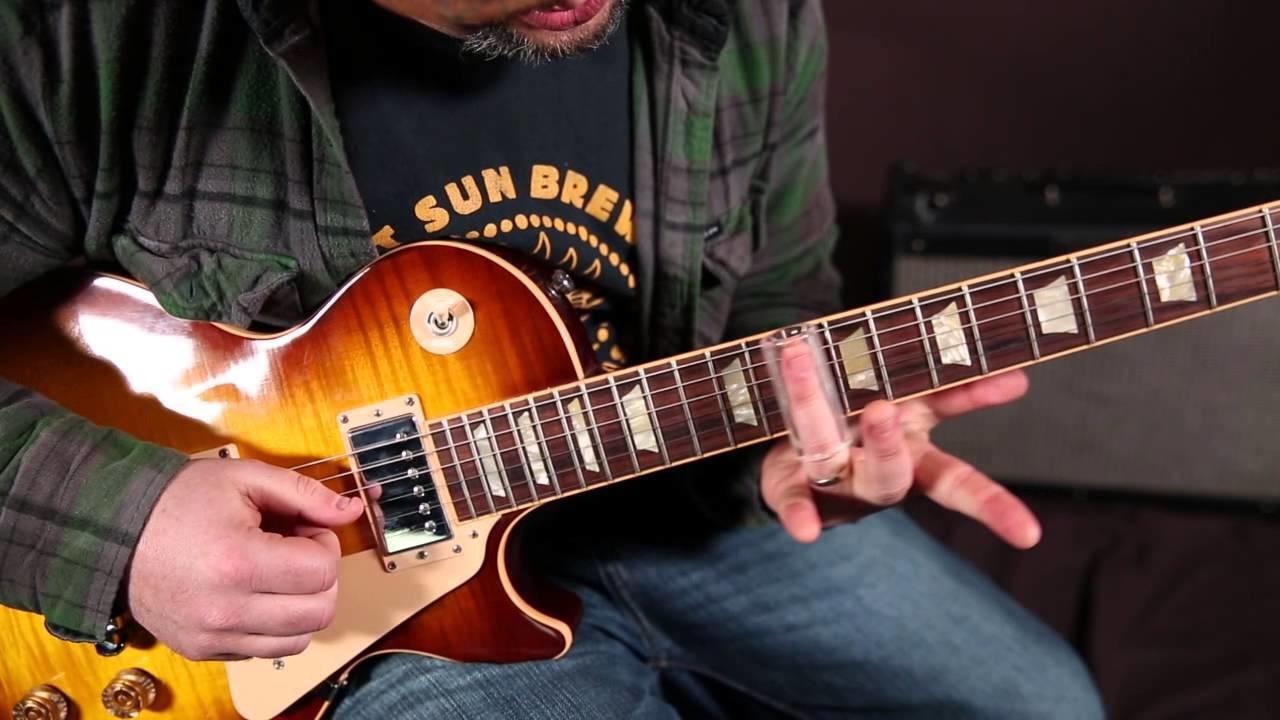 Someone playing slide guitar on a Les Paul