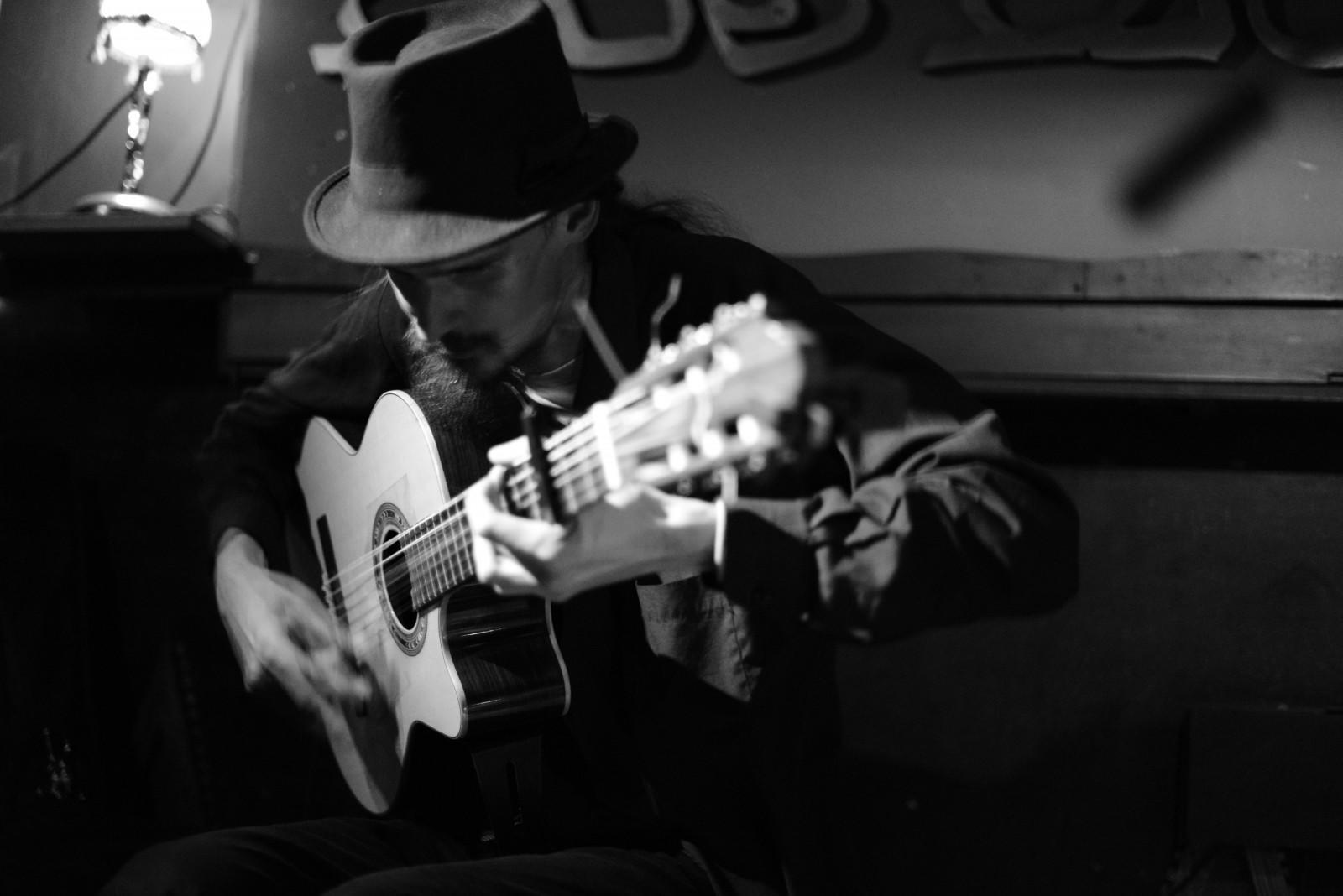 A man plays the guitar passionately