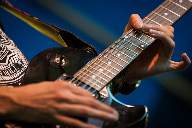 Someone playing a second-hand electric guitar.