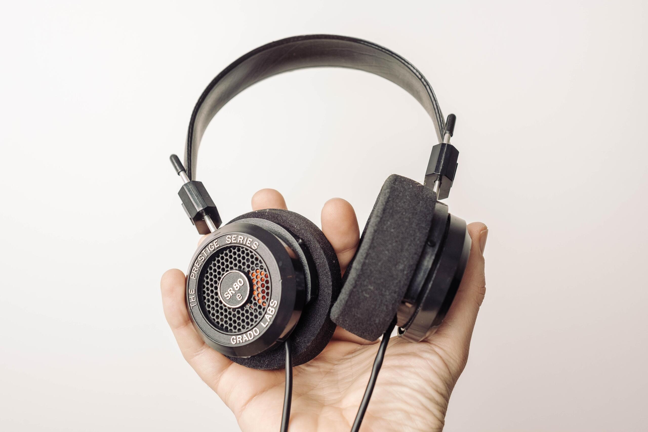 A hand holding headphones in the air