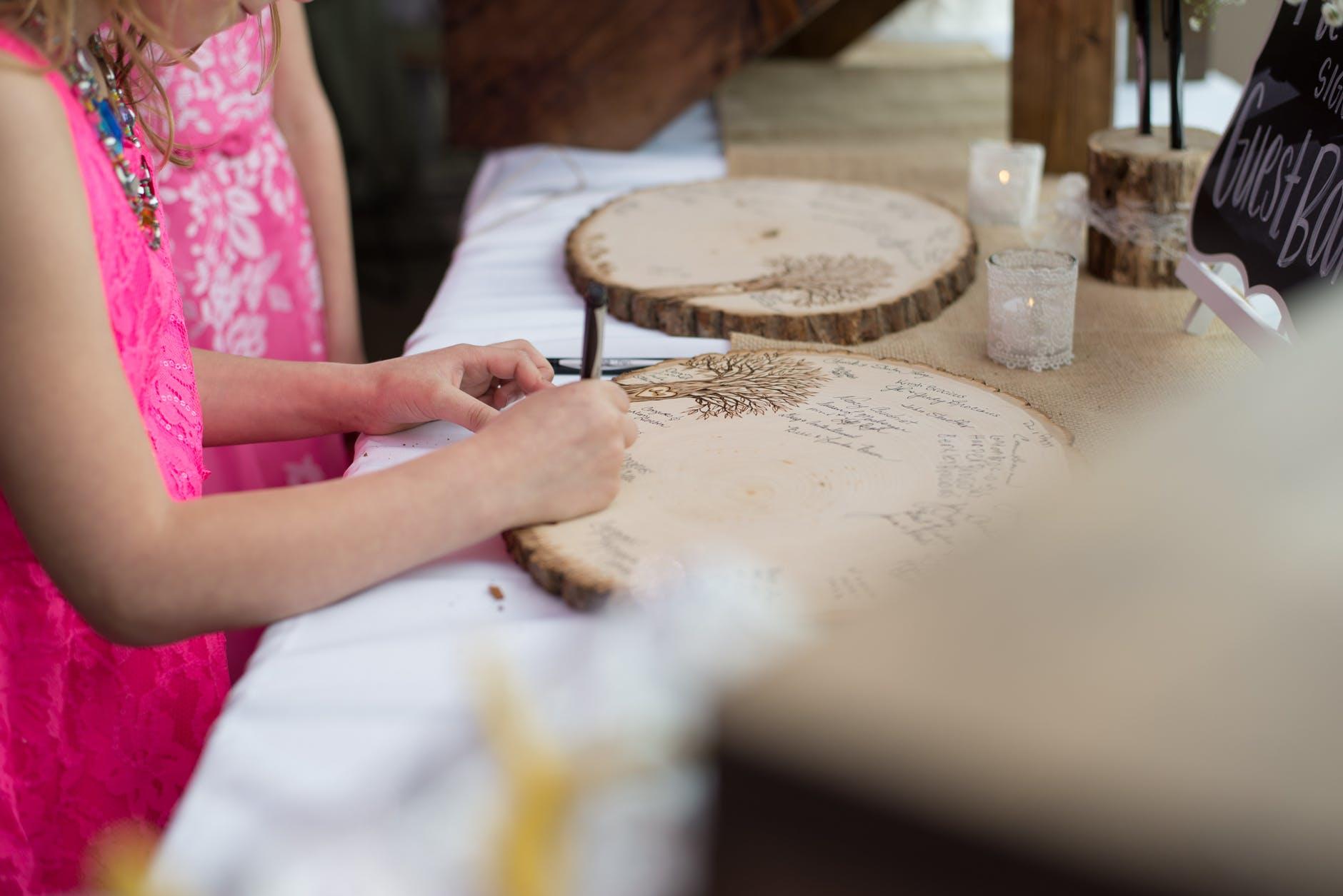Kind schrijft op houten paneel