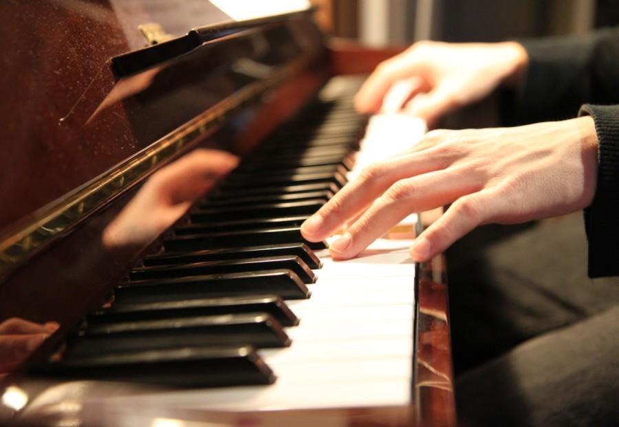 handen op pianotoetsen