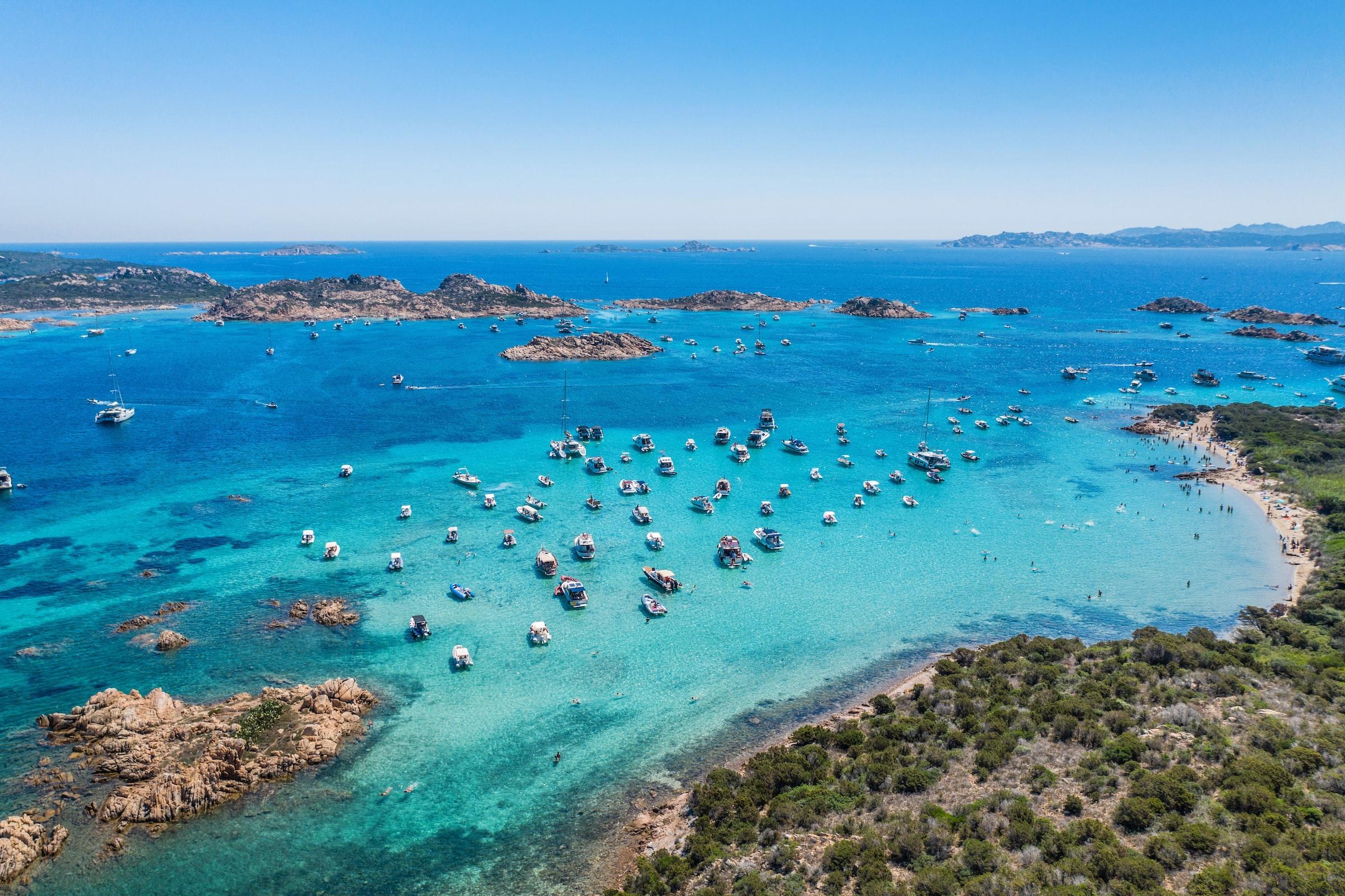 De kust van Sardinië met veel aangelegde boten