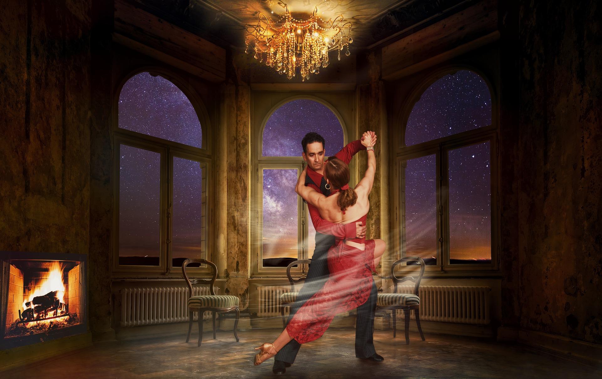 Paar danst de Tango in verlichte donkere ruimte