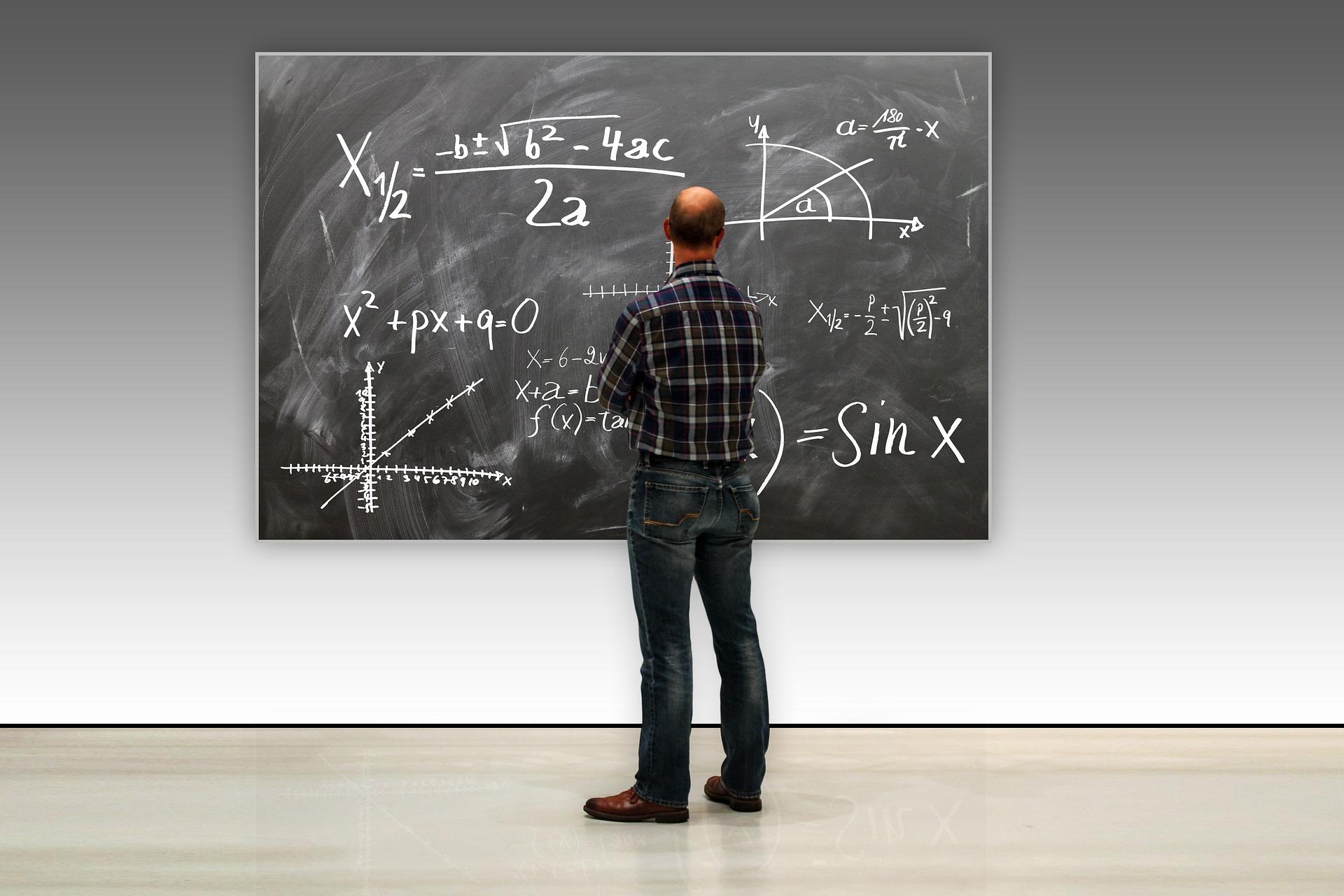 Persoon staat voor school bord met formules