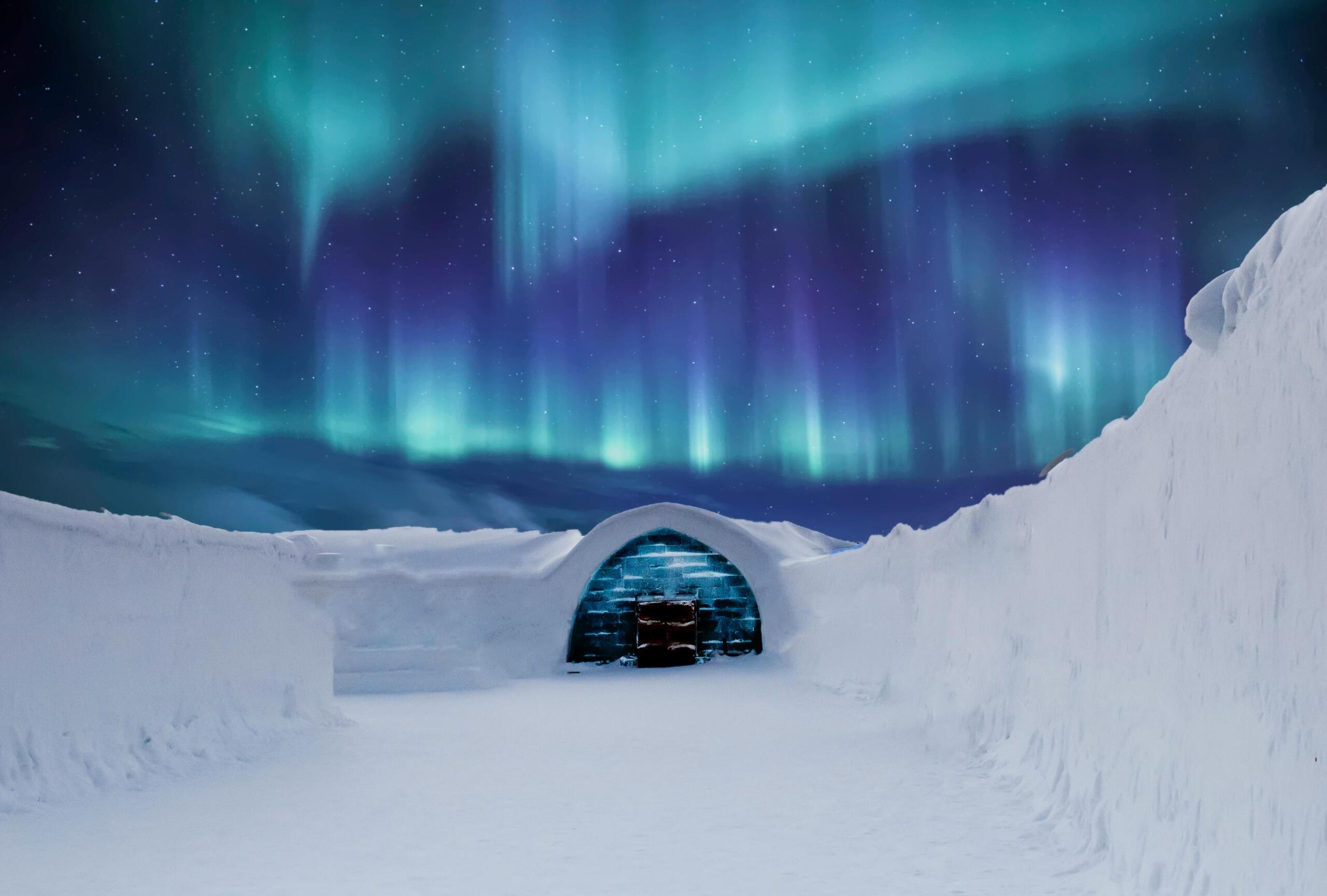 Een iglo van sneeuw staat onder een hemel vol kleurrijk noorderlicht in een arctisch landschap.