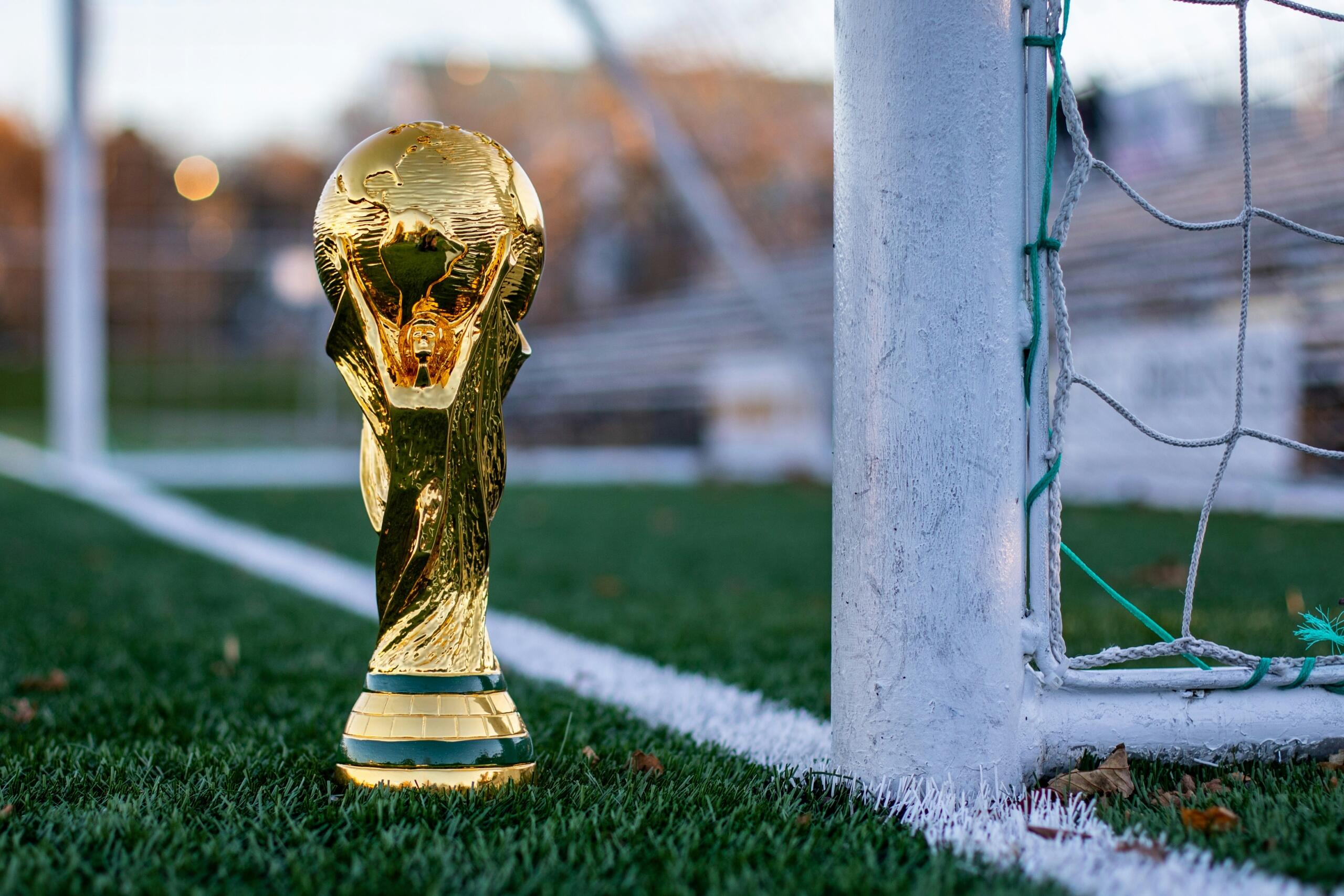 Een gouden trofee staat op een grasveld.