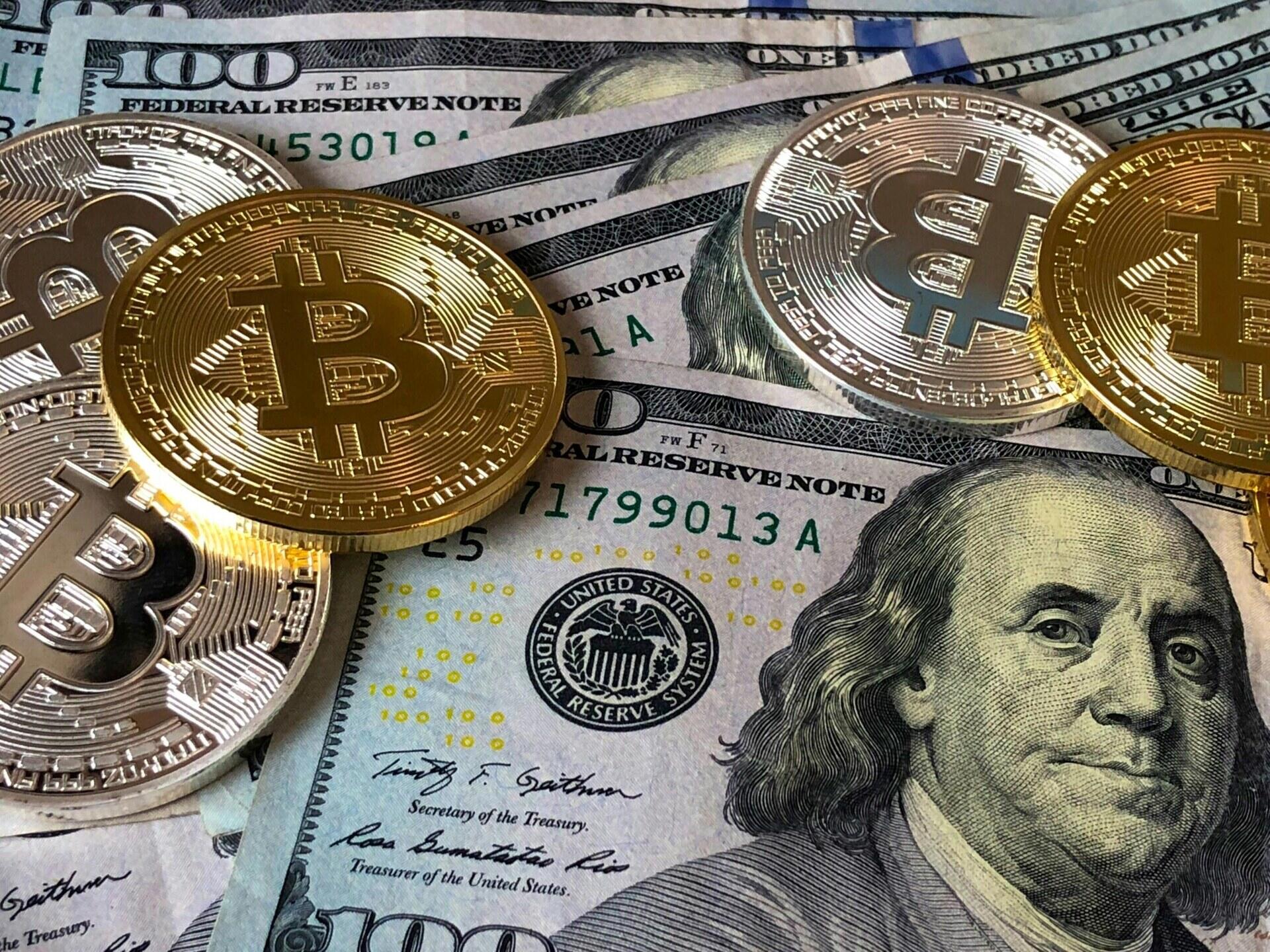 Bitcoinmunten liggen op Amerikaanse dollarbiljetten
