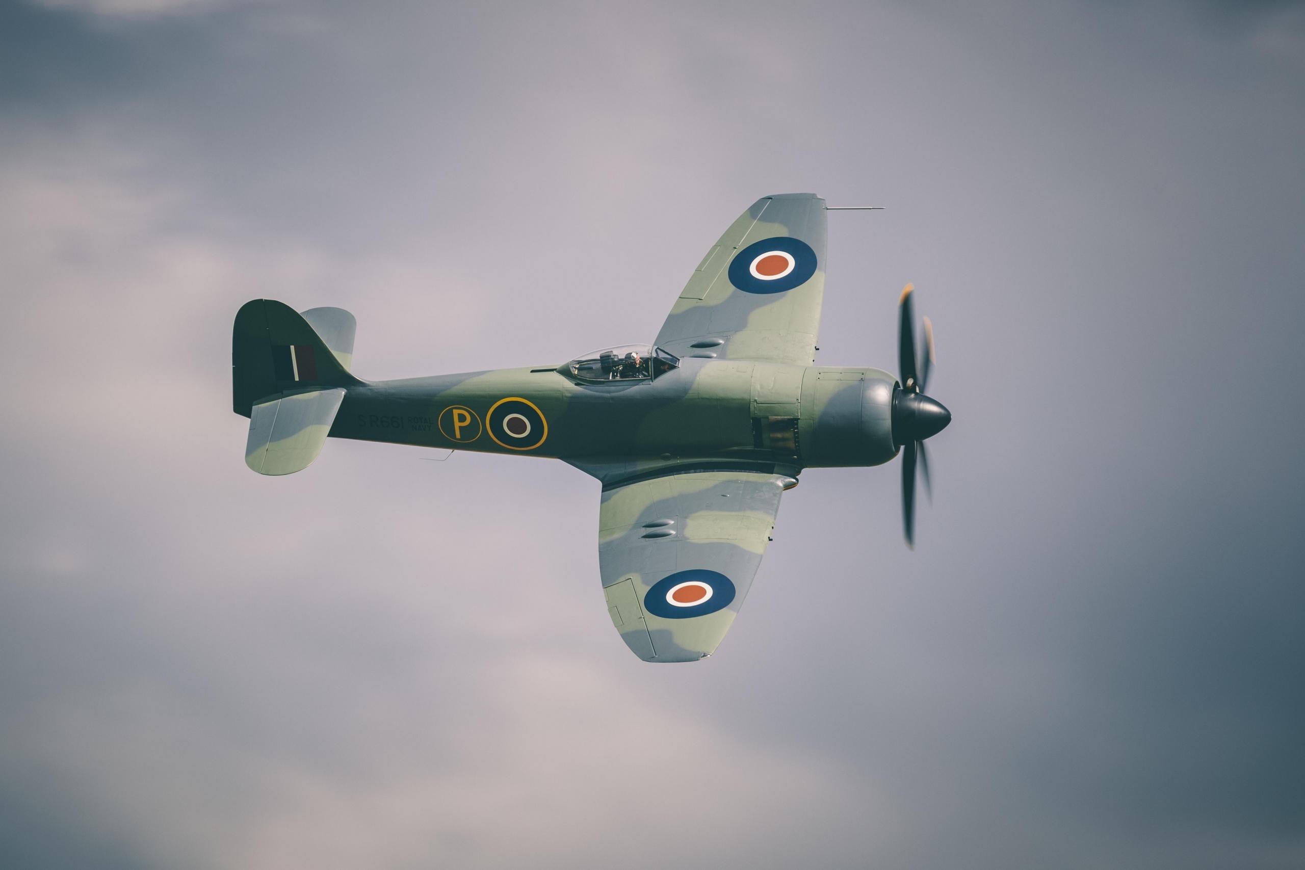 Et engelsk krigsfly flyr foran en tåkete himmel