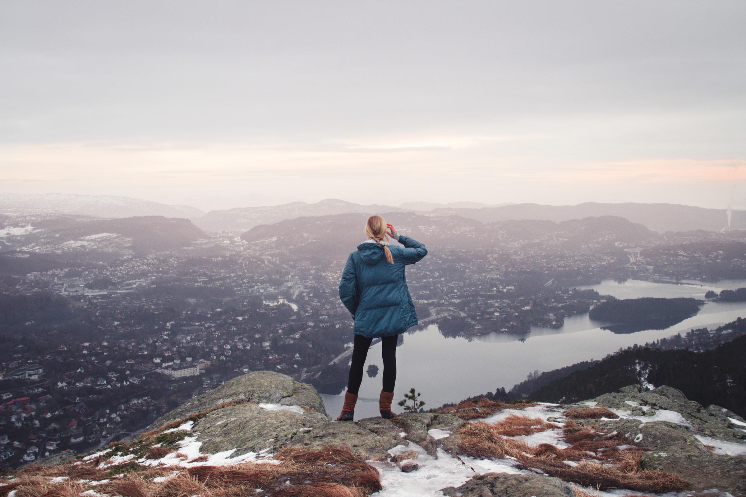 kvinne speider utover fjellhorisonten