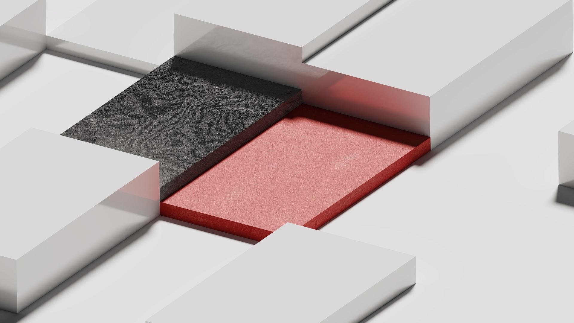 3D-design med hvite bokser, en rød og en svart