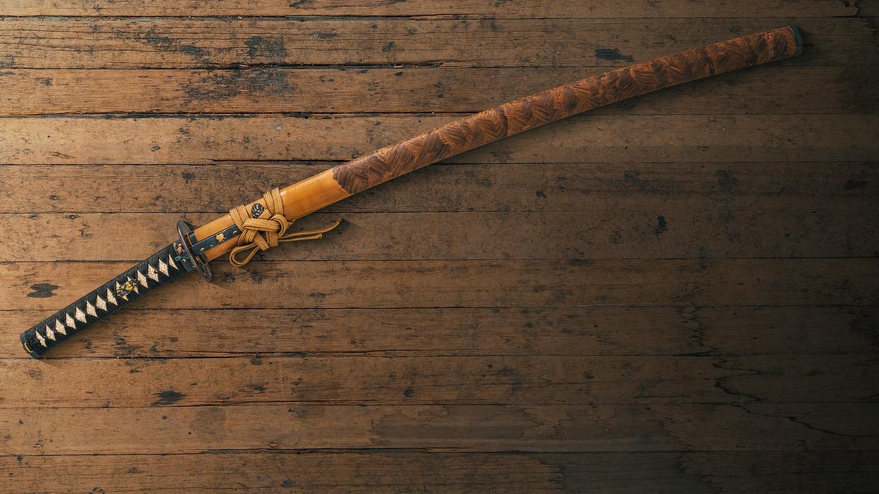 En tradisjonell katana med intrikate detaljer på håndtaket, plassert på et trebord.