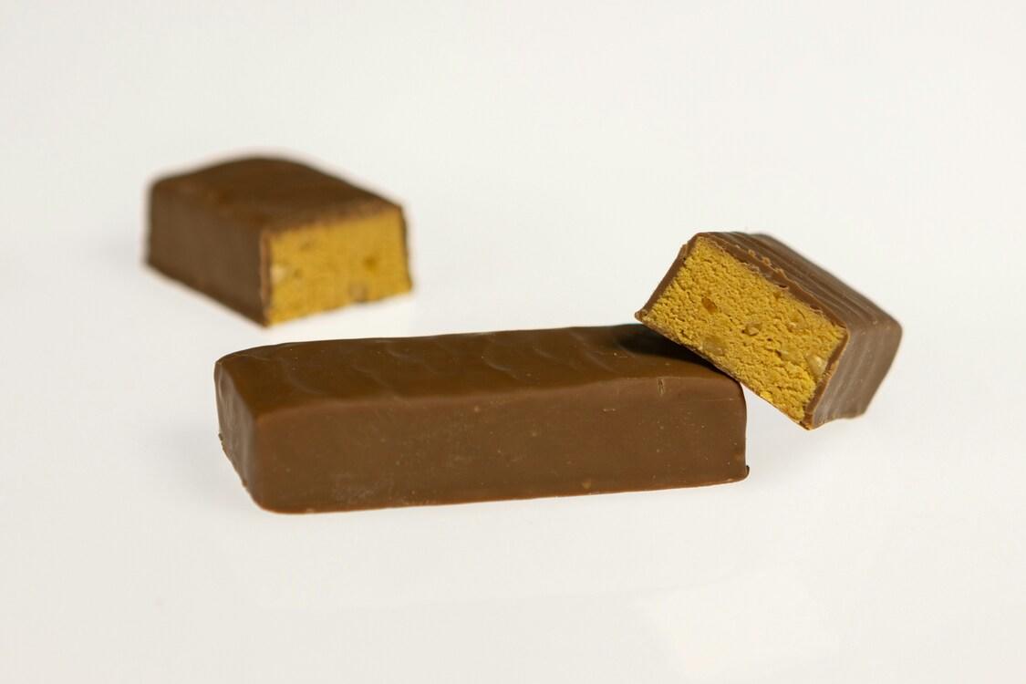 En proteinbar delt i to, liggende på en hvit bakgrunn.