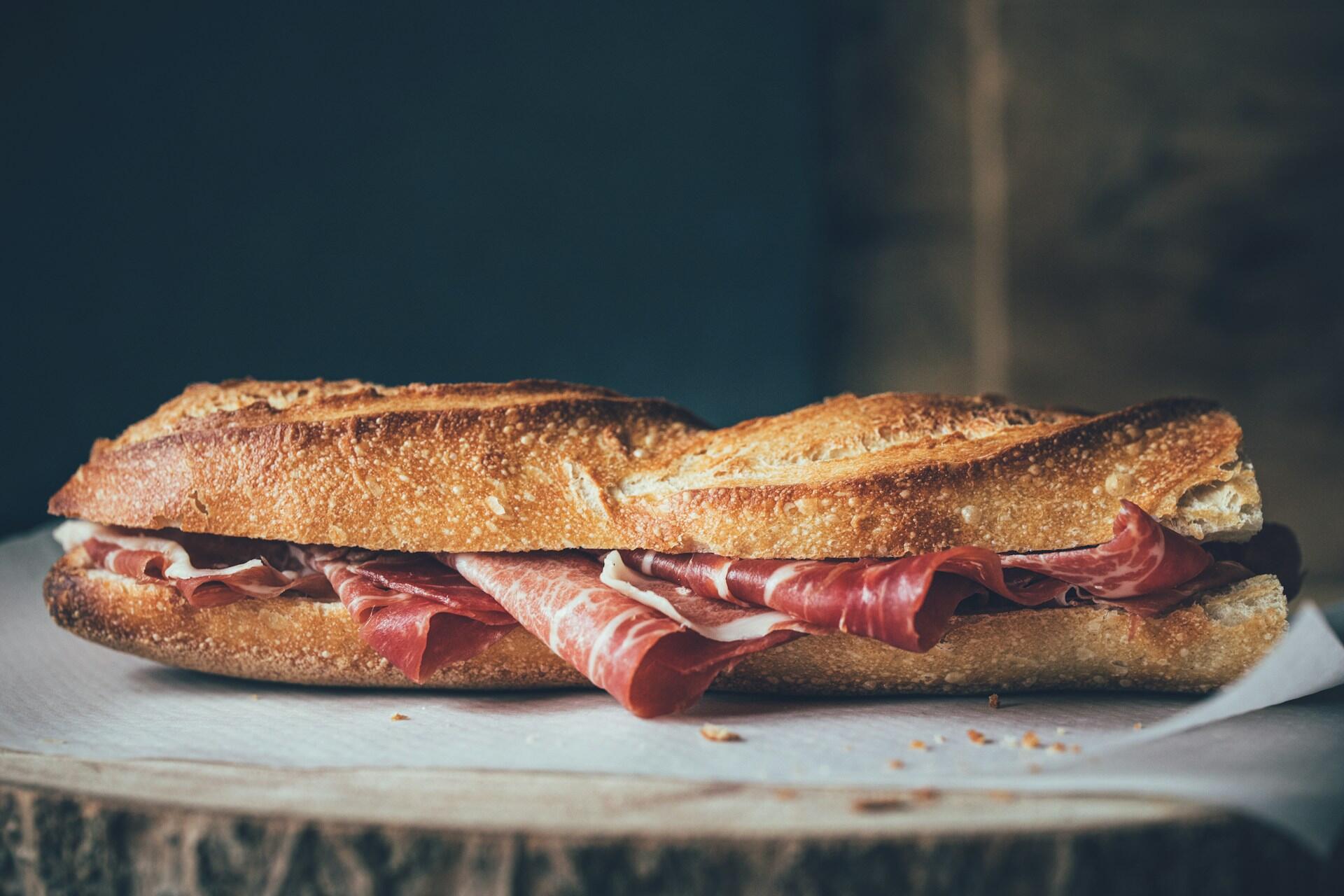 En appetittvekkende baguette fylt med spansk serranoskinke. Perfekt for en smakfull lunsj eller snack mens du utforsker Spania.