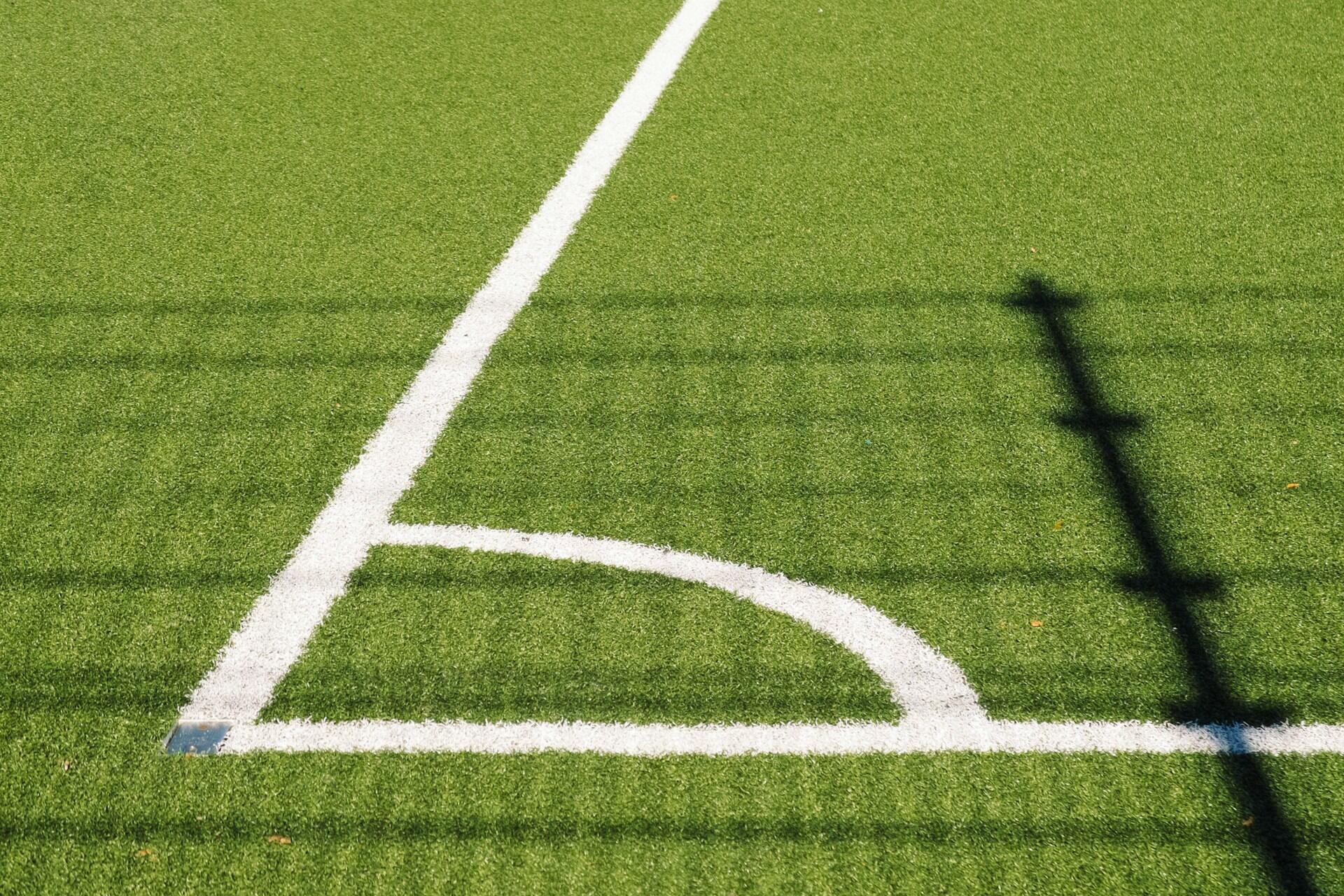 Hjørnet av en fotballbane tegnet opp på kunstgress