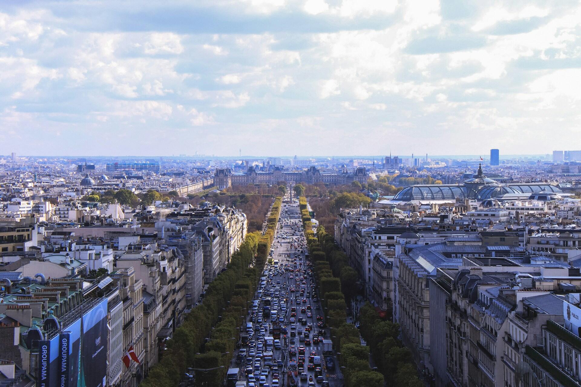Mye trafikk nedover Champs Elysées i Paris.