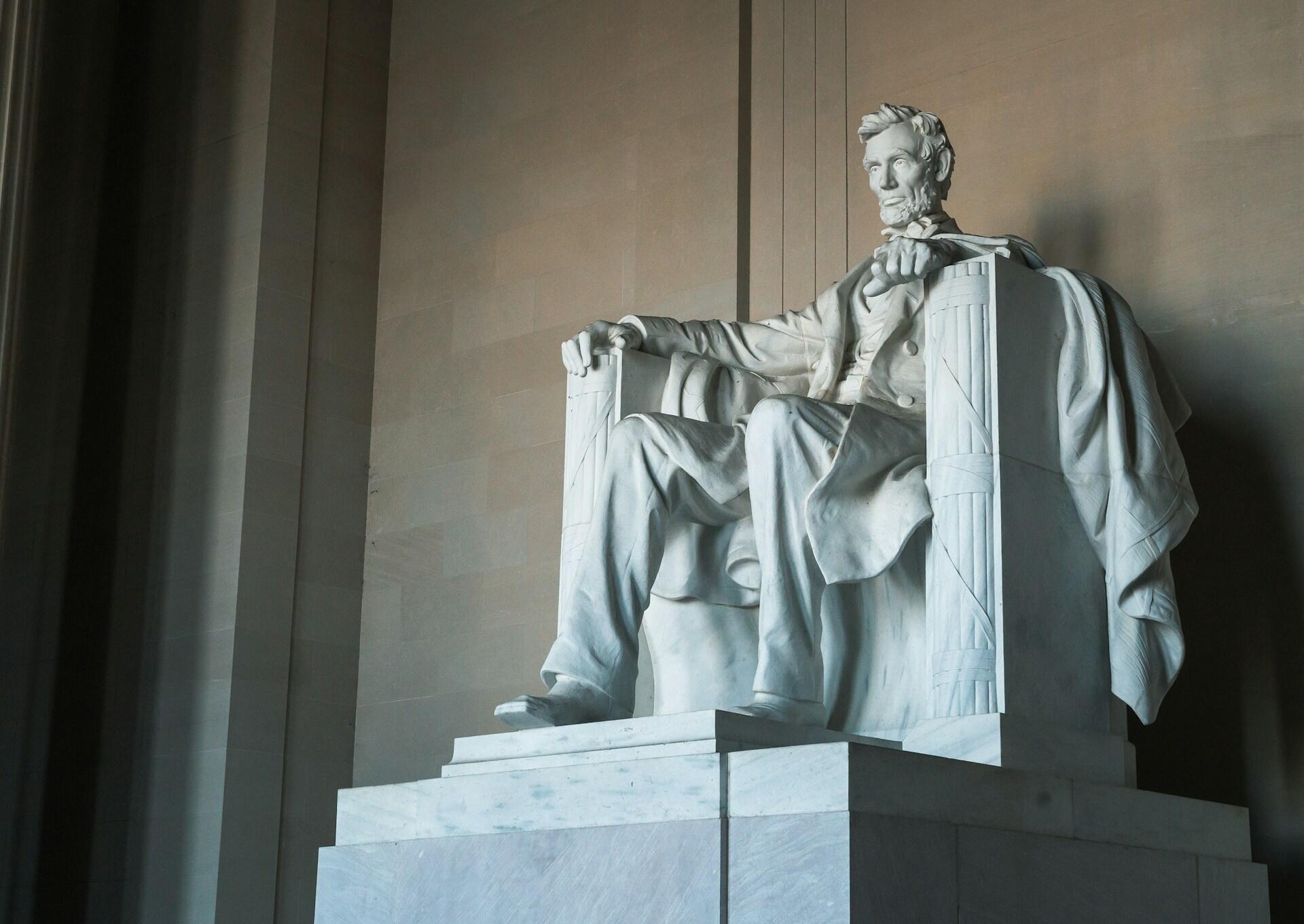 Stor marmorskulptur av Abraham Lincoln sittende i stol, inne i Lincoln Memorial i Washington D.C.