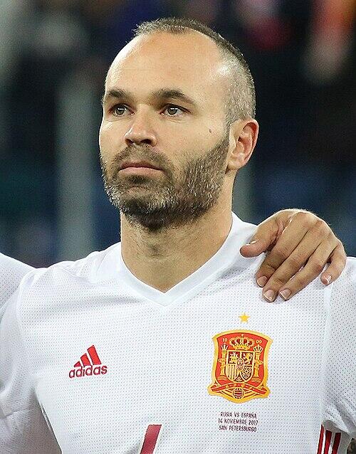 Andrés Iniesta står på fotballbanen i drakten til Spanias landslag.