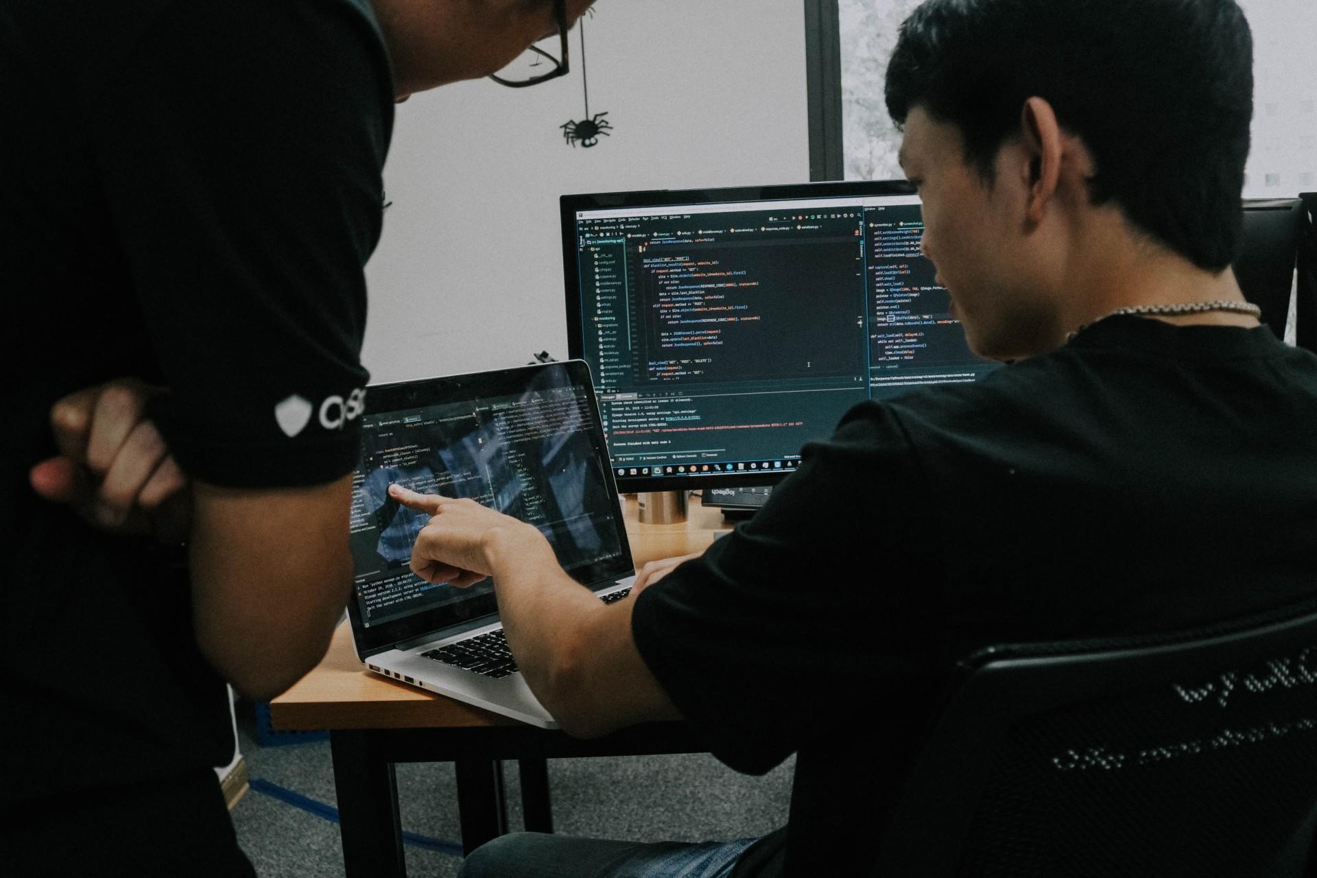 One man explaining code to another