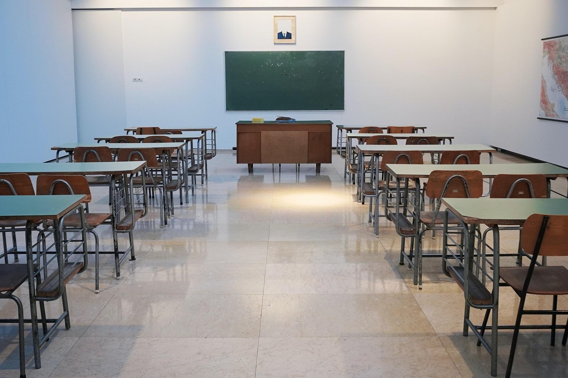 Empty classroom with desks and a blackboard