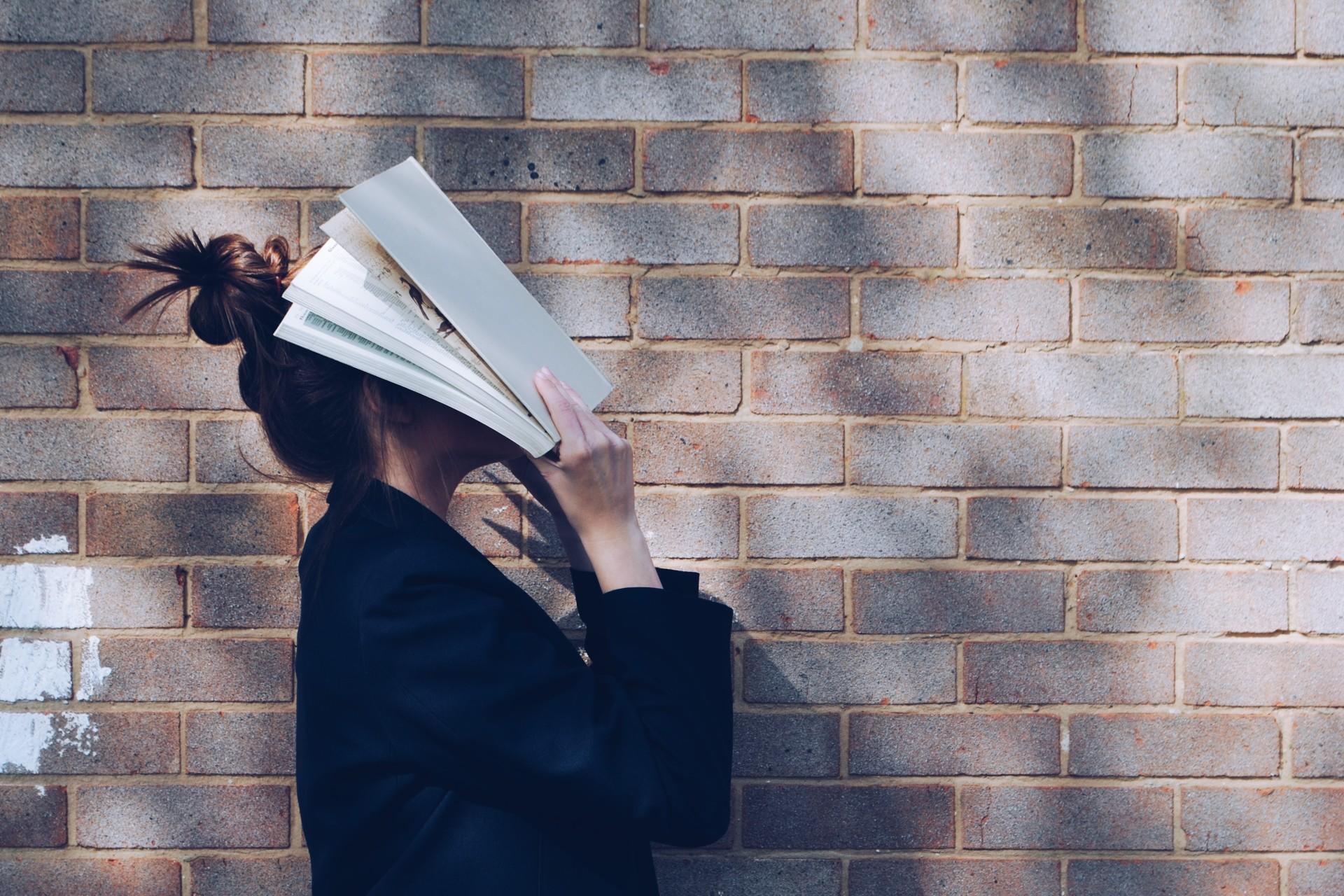 A woman with a book over her face