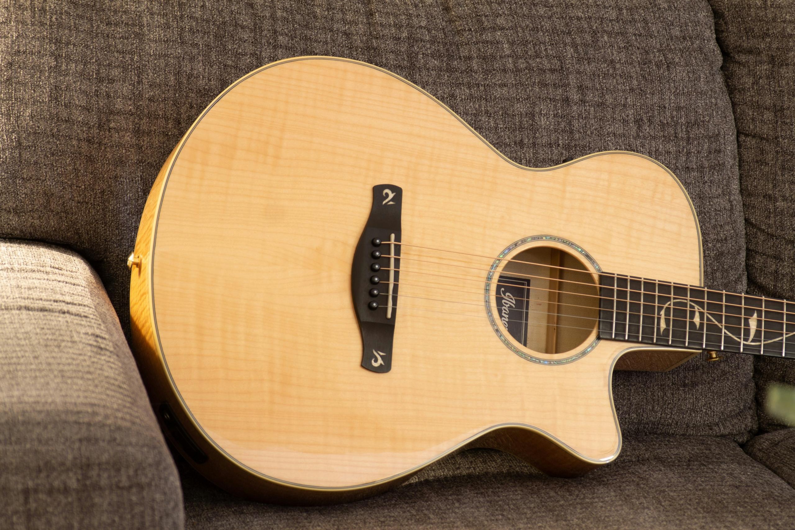 Jumbo acoustic guitar on couch