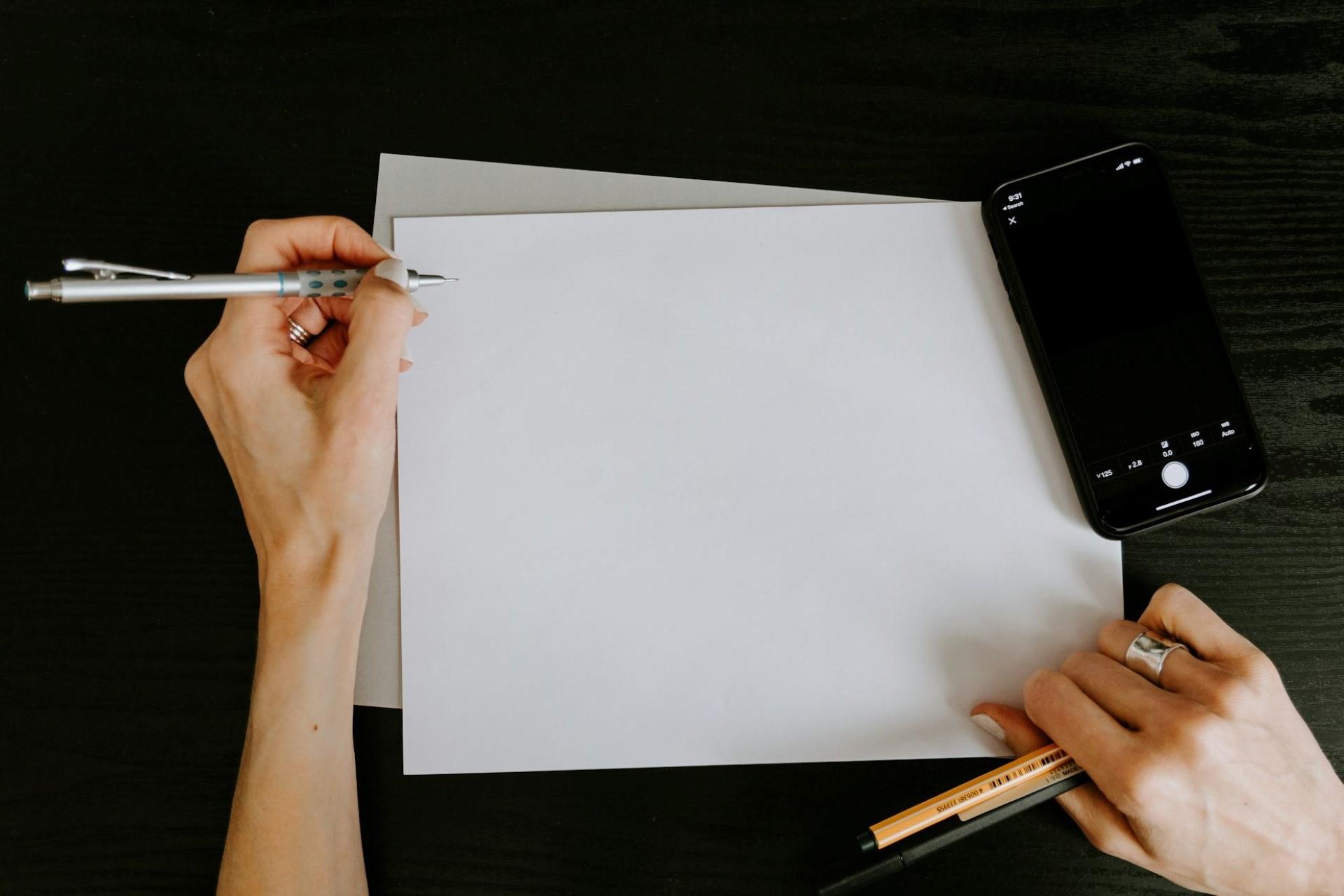 A person with a pen and some paper.