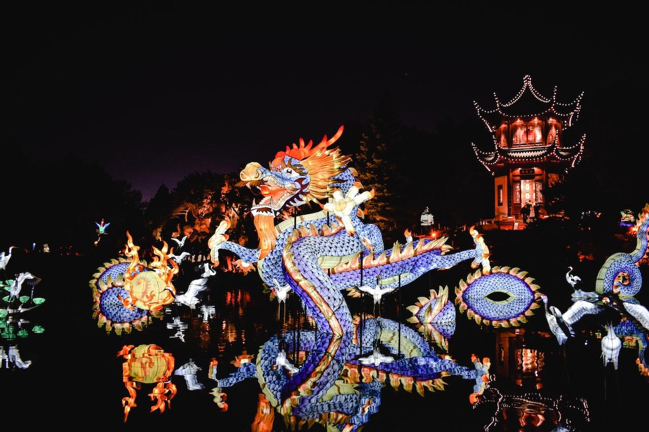 A blue dragon light-up display dances for a festival.