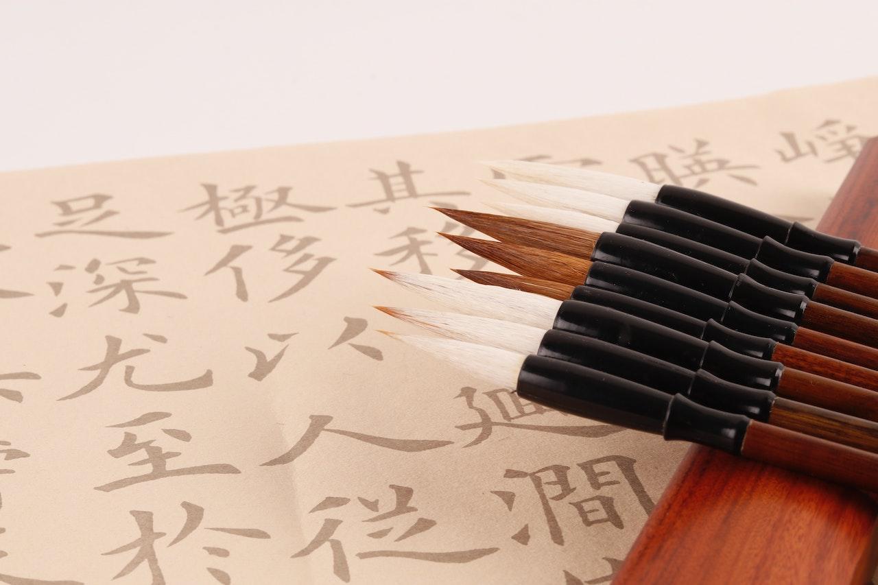 Chinese calligraphy beautifully written on parchment with brushes.